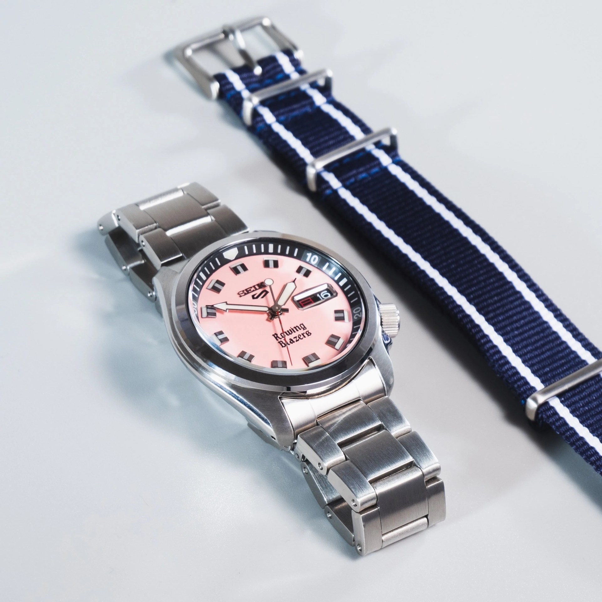 seiko x rowing blazers collab watch on steel bracelet next to colorful nato strap