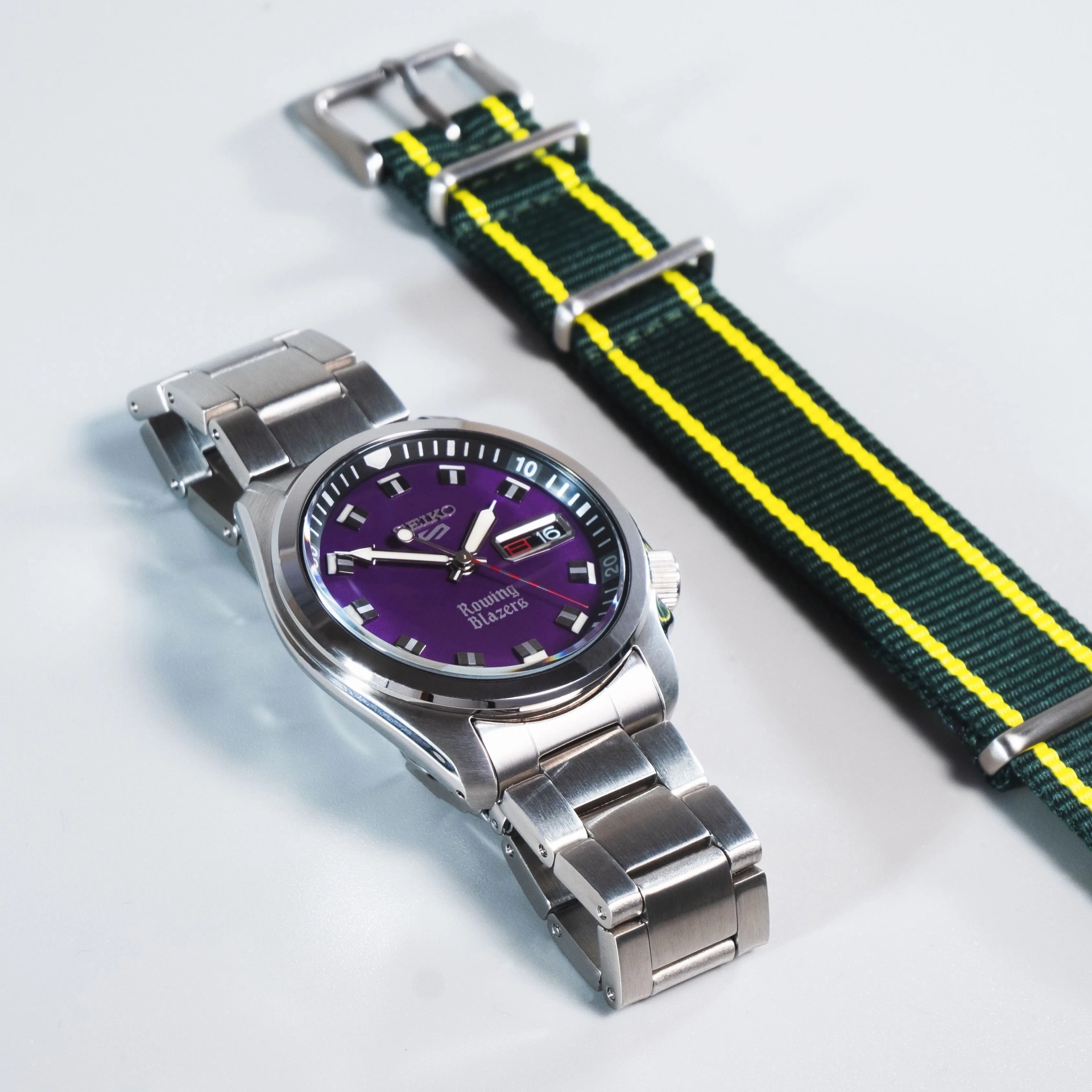seiko x rowing blazers collab watch on steel bracelet next to colorful nato strap