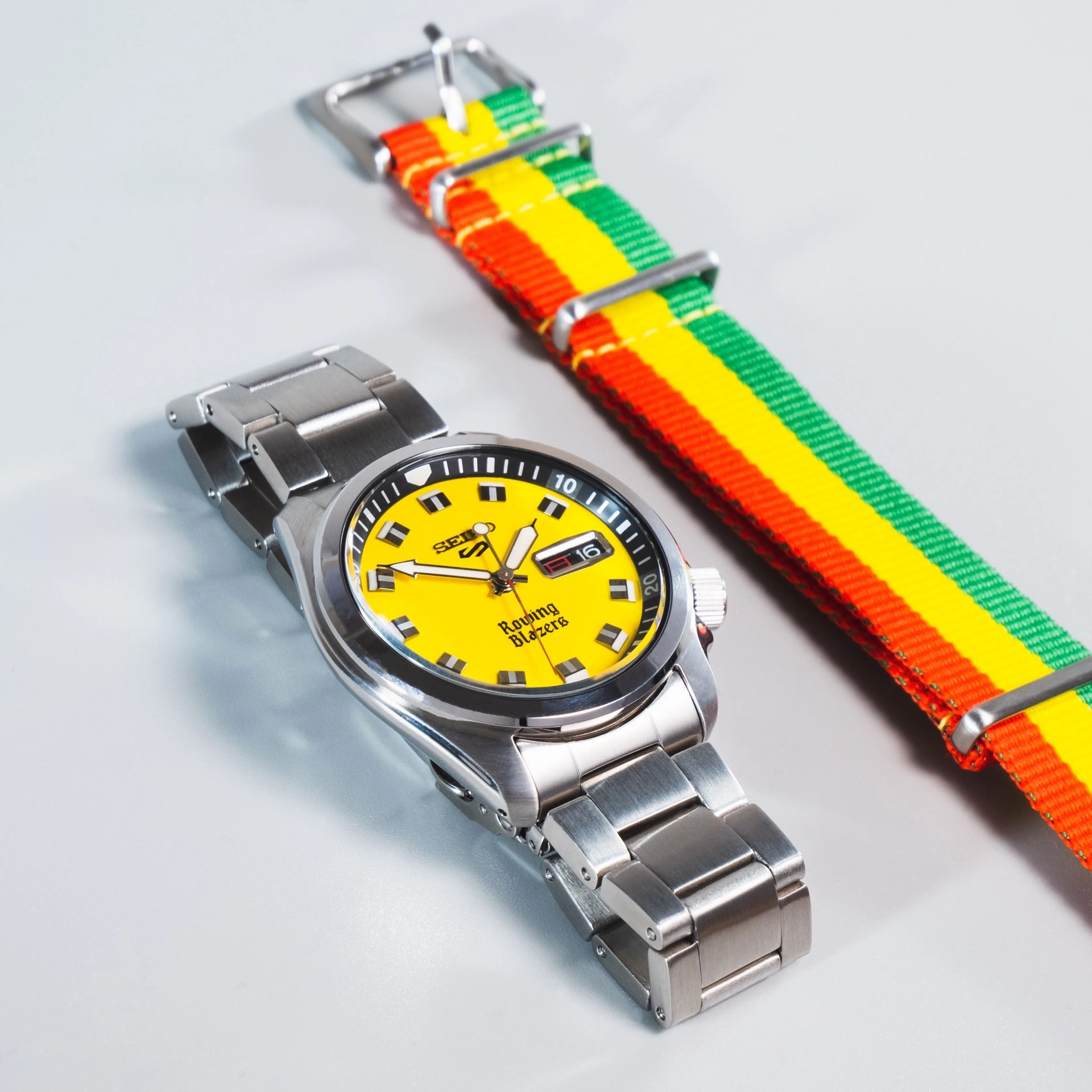 seiko x rowing blazers collab watch on steel bracelet next to colorful nato strap