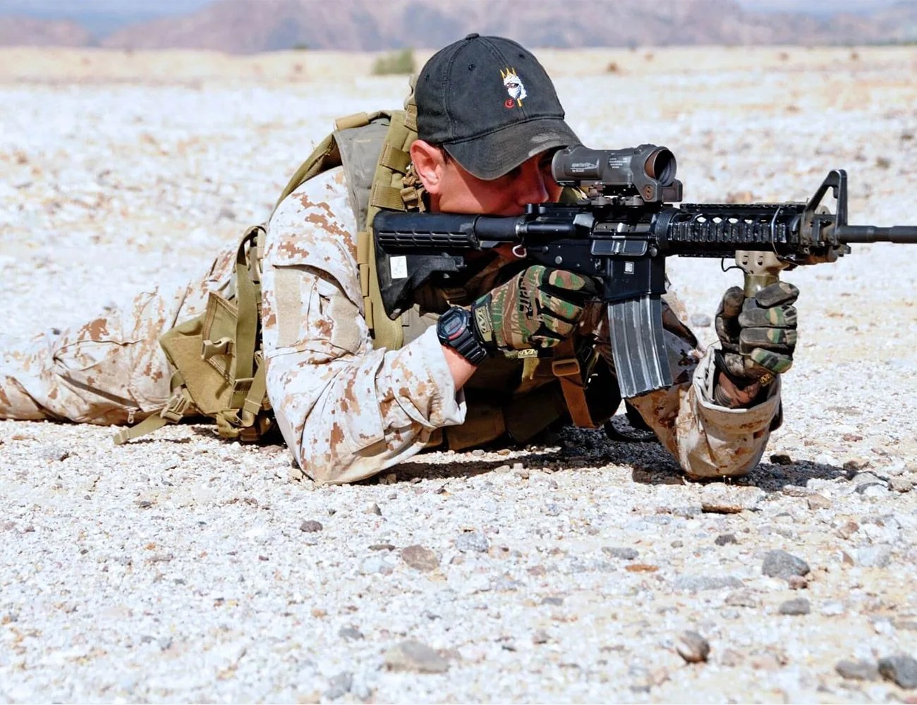military personnel holding a gun wearing a g shock watch