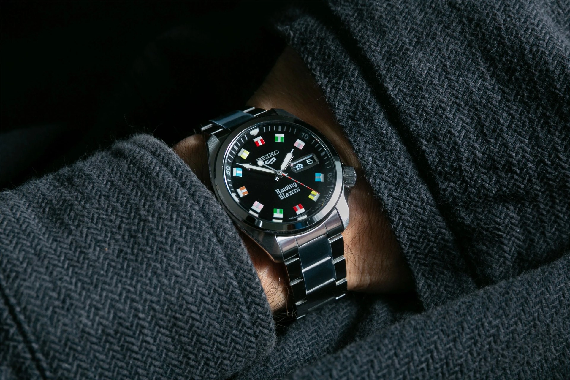 someone wearing a seiko 5 watch