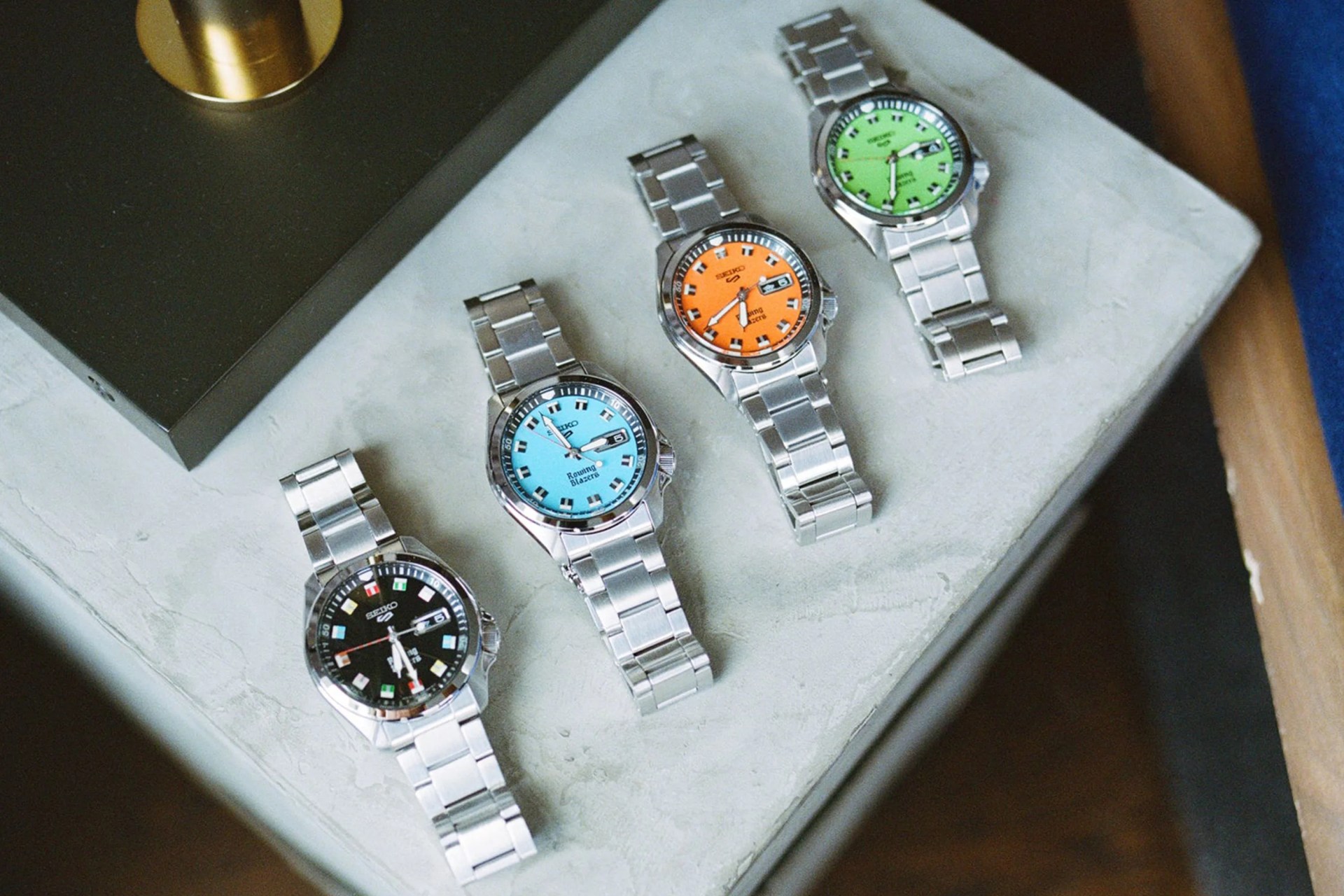 four watches on a stone counter