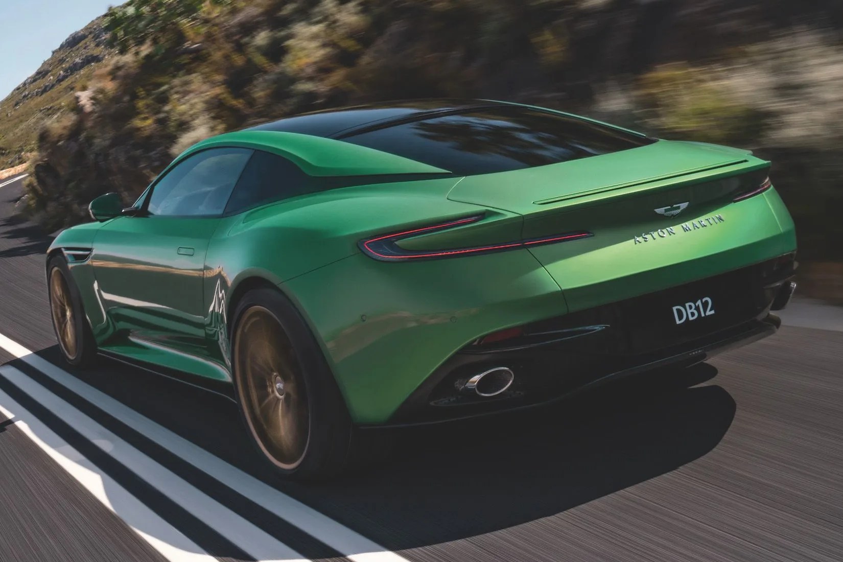aston martin db12 on road from the rear