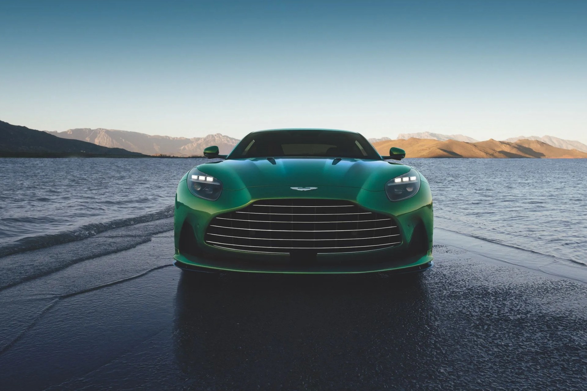 aston martin db12 parked on the beach