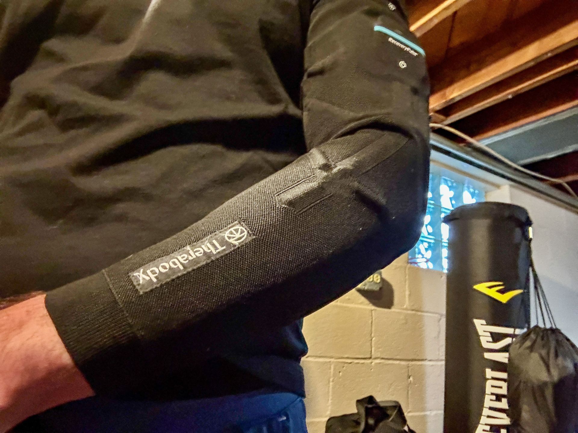 a man wearing the therabody recoverypulse collection