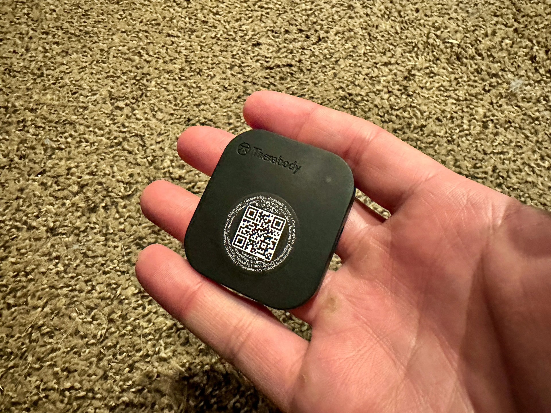 a person holding the micro motor chip of the therabody recoverypulse collection