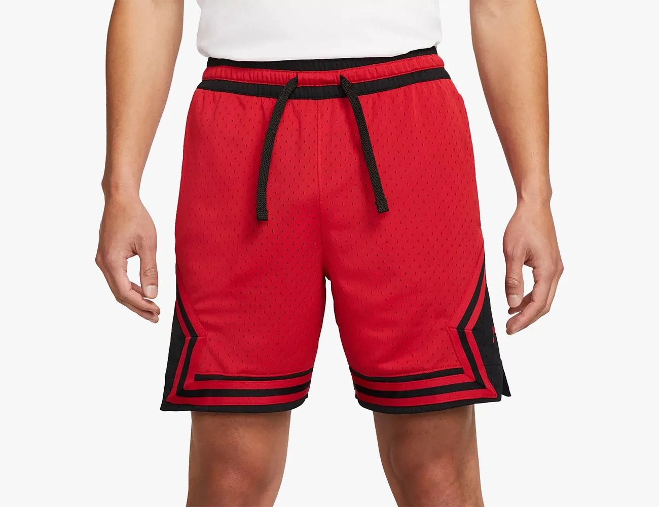 a person wearing red and black shorts