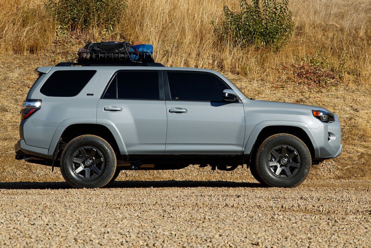 toyota 4runner parked next to a mountain ranch fence