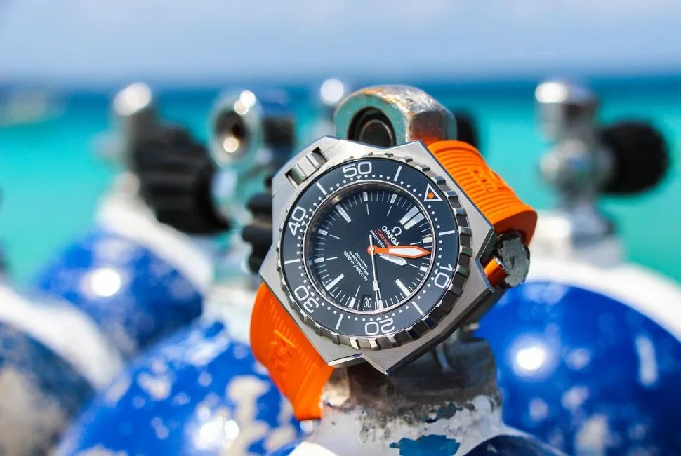 omega seamaster ploprof watch with diving equipment