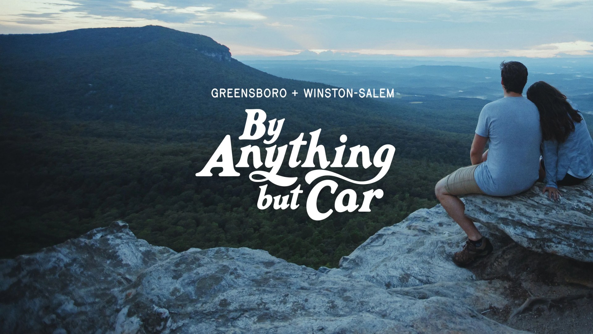 Greensboro + Nantahala By Anything But Car a couple sitting along a rocky cliff