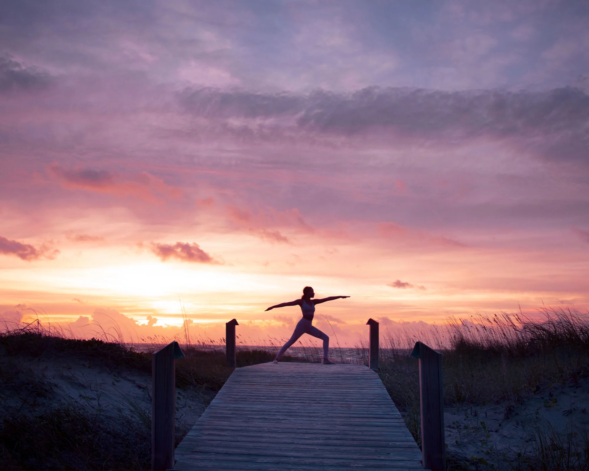 woman doing yoga at a sunset