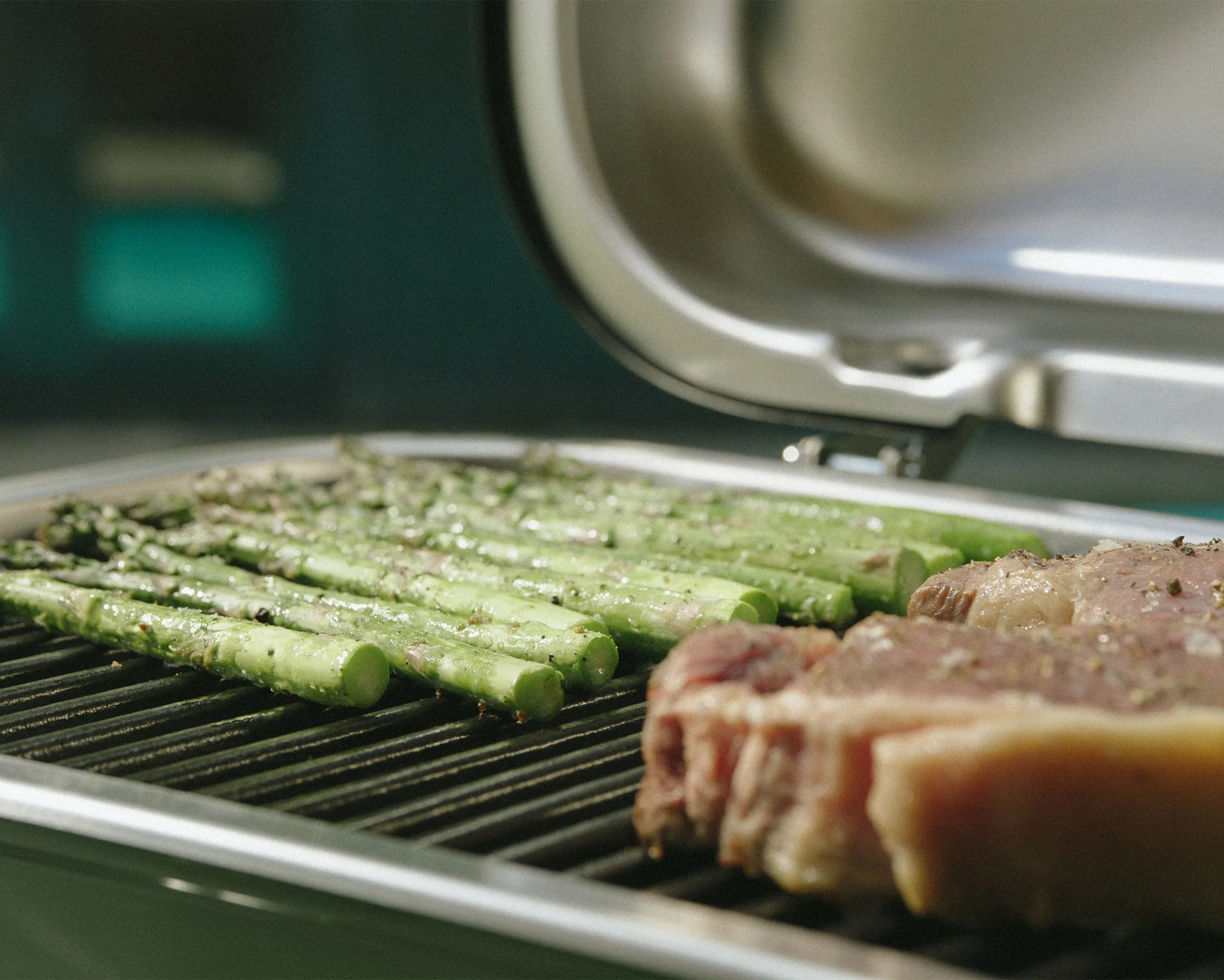 asparagus and steak grilling on a weber grill