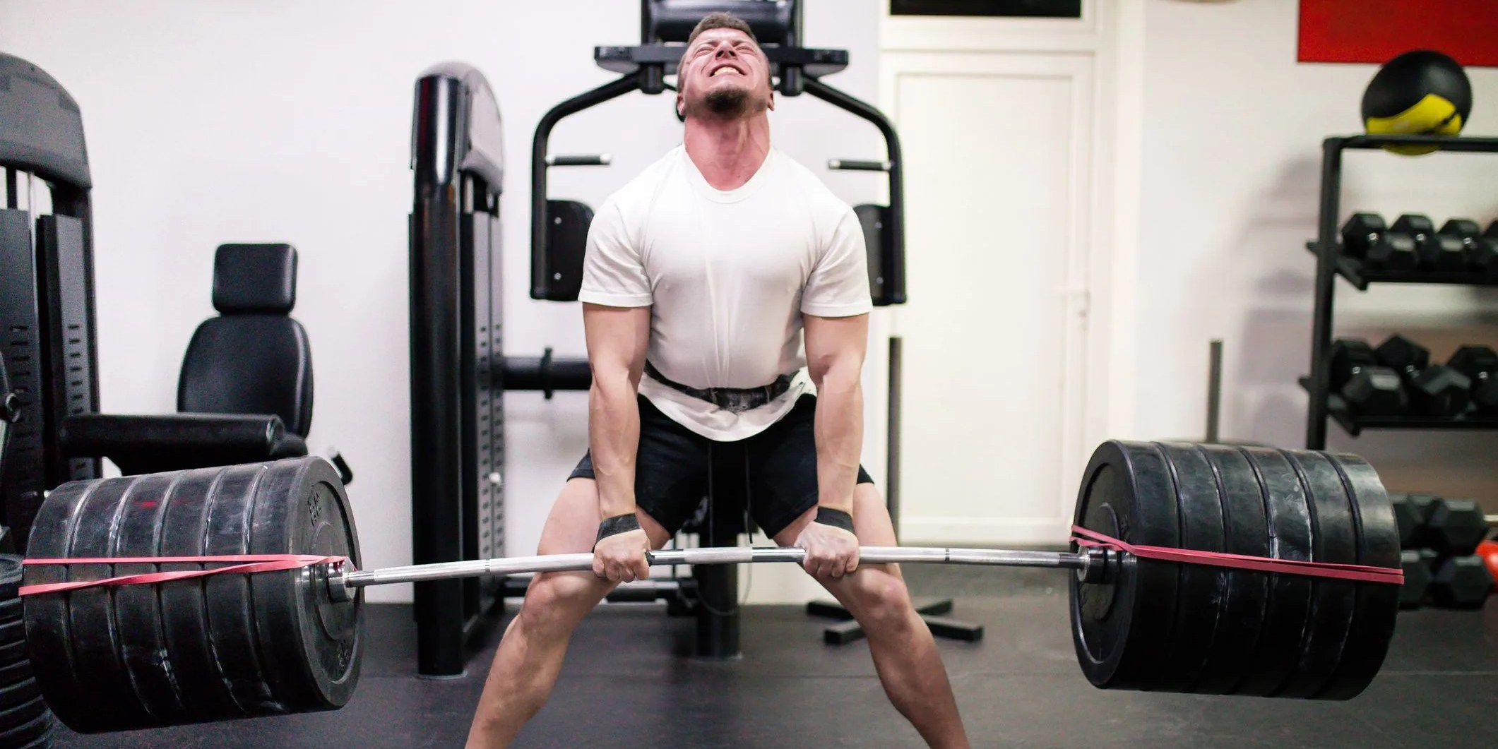 athletes lifting barbells exercise at gym