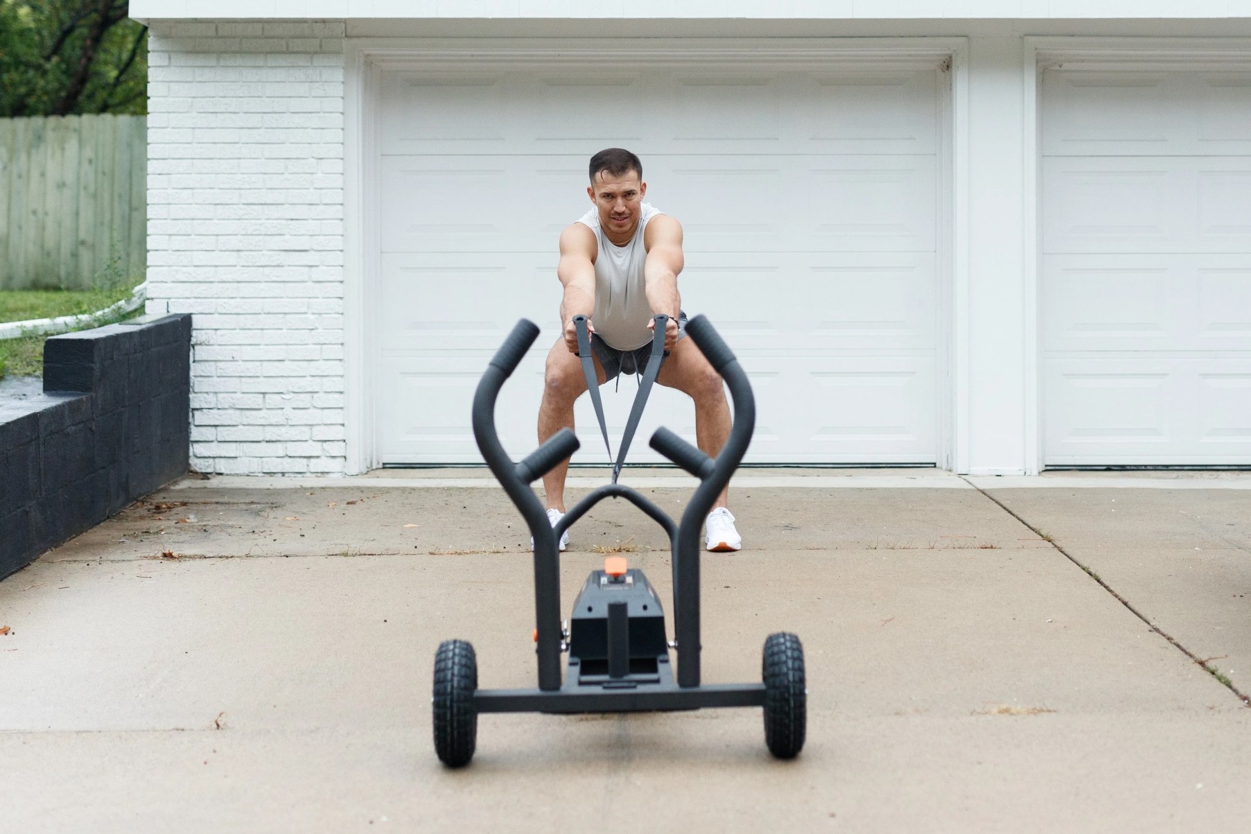 a man pulling a tank m1 push sled