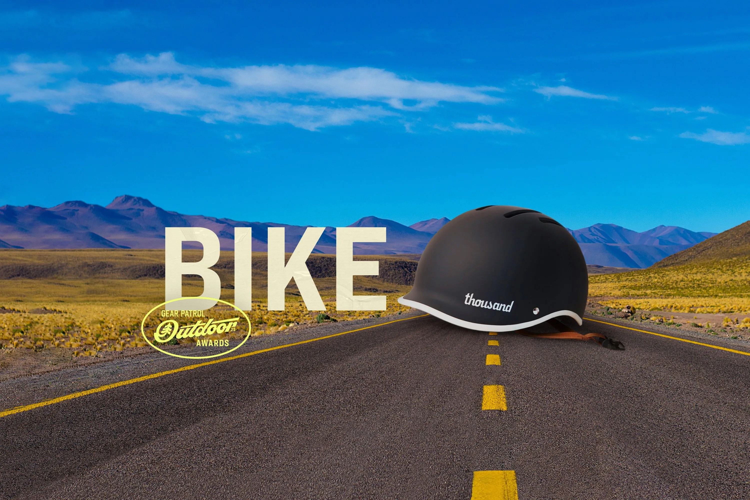 a helmet on a road landscape with a bike headline and outdoor badge icon