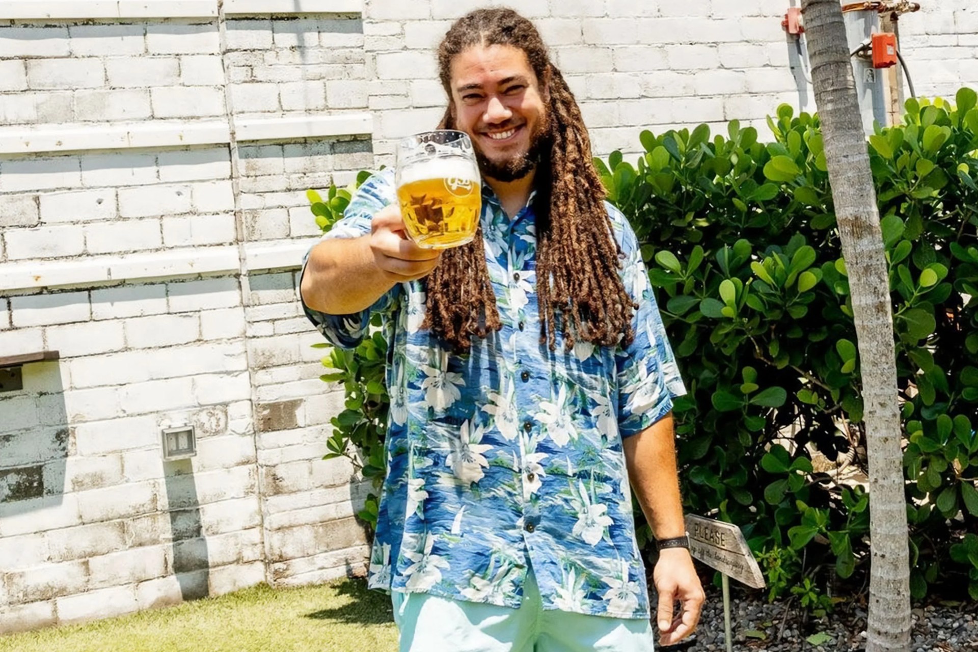 green bench brewing founder holding a glass of beer