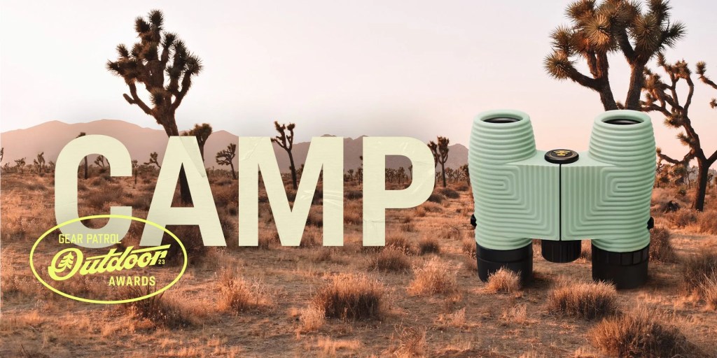 binoculars in a desert landscape with a camp headline and outdoor badge icon