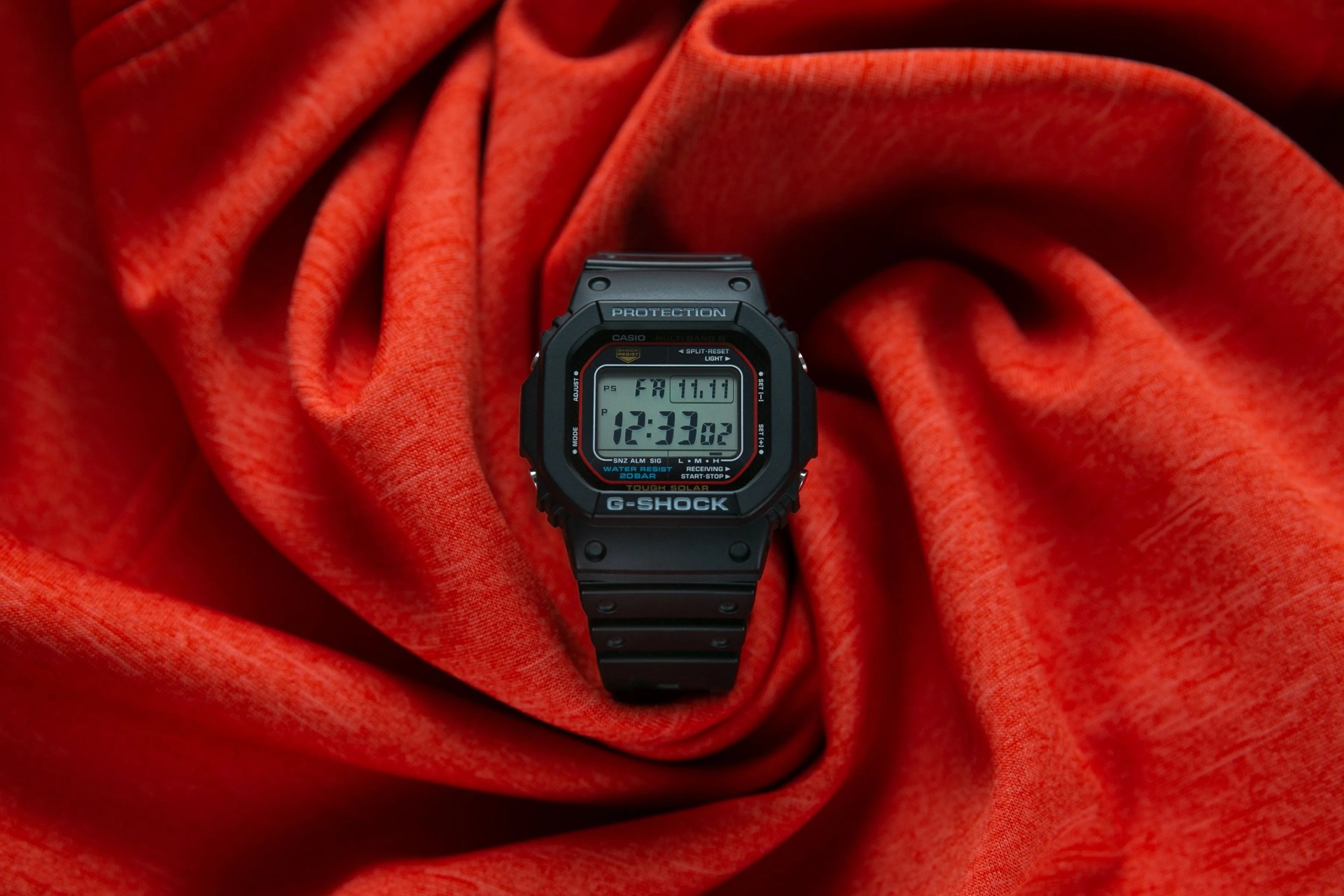 casio watch on red fabric