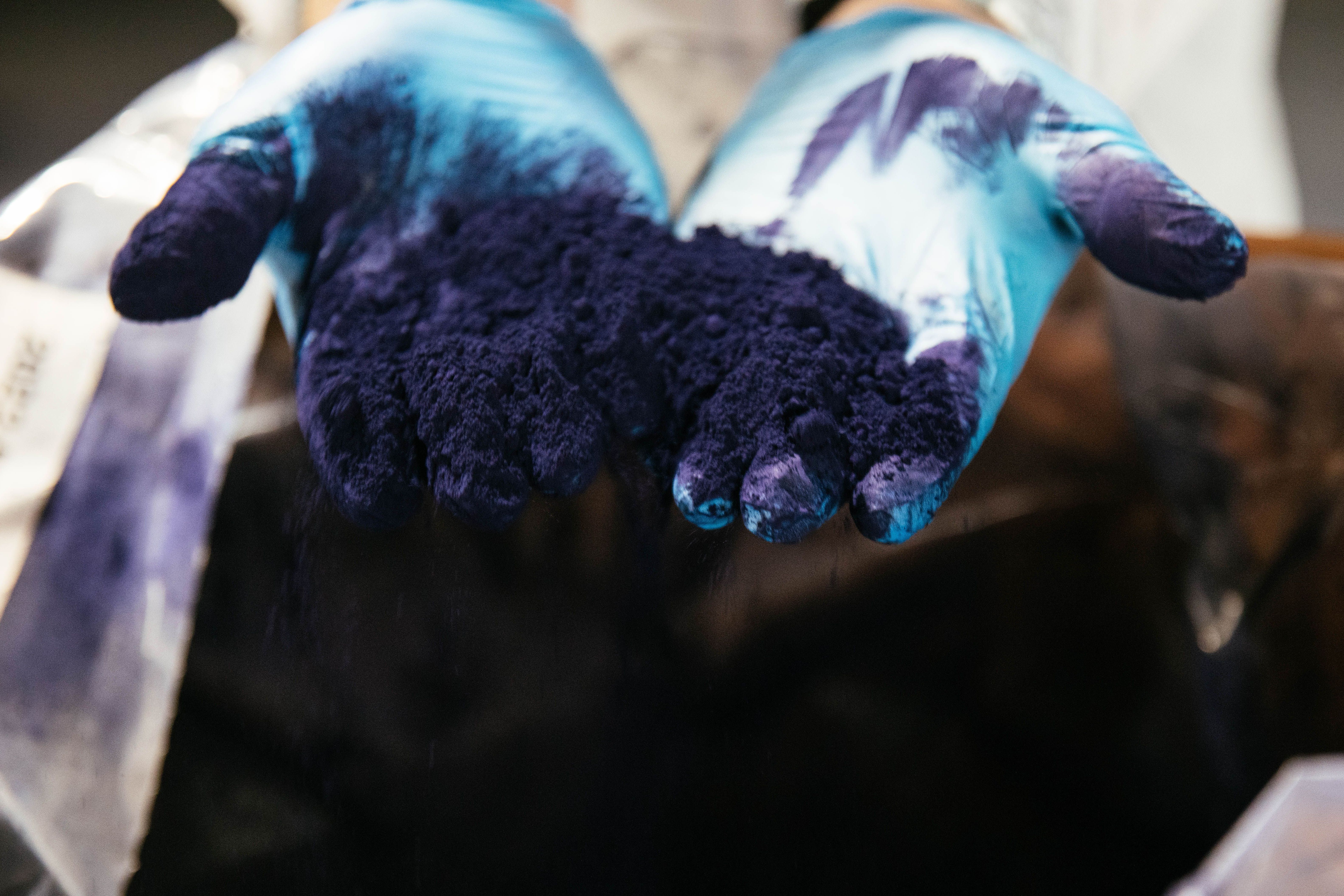a person holding indigo powder