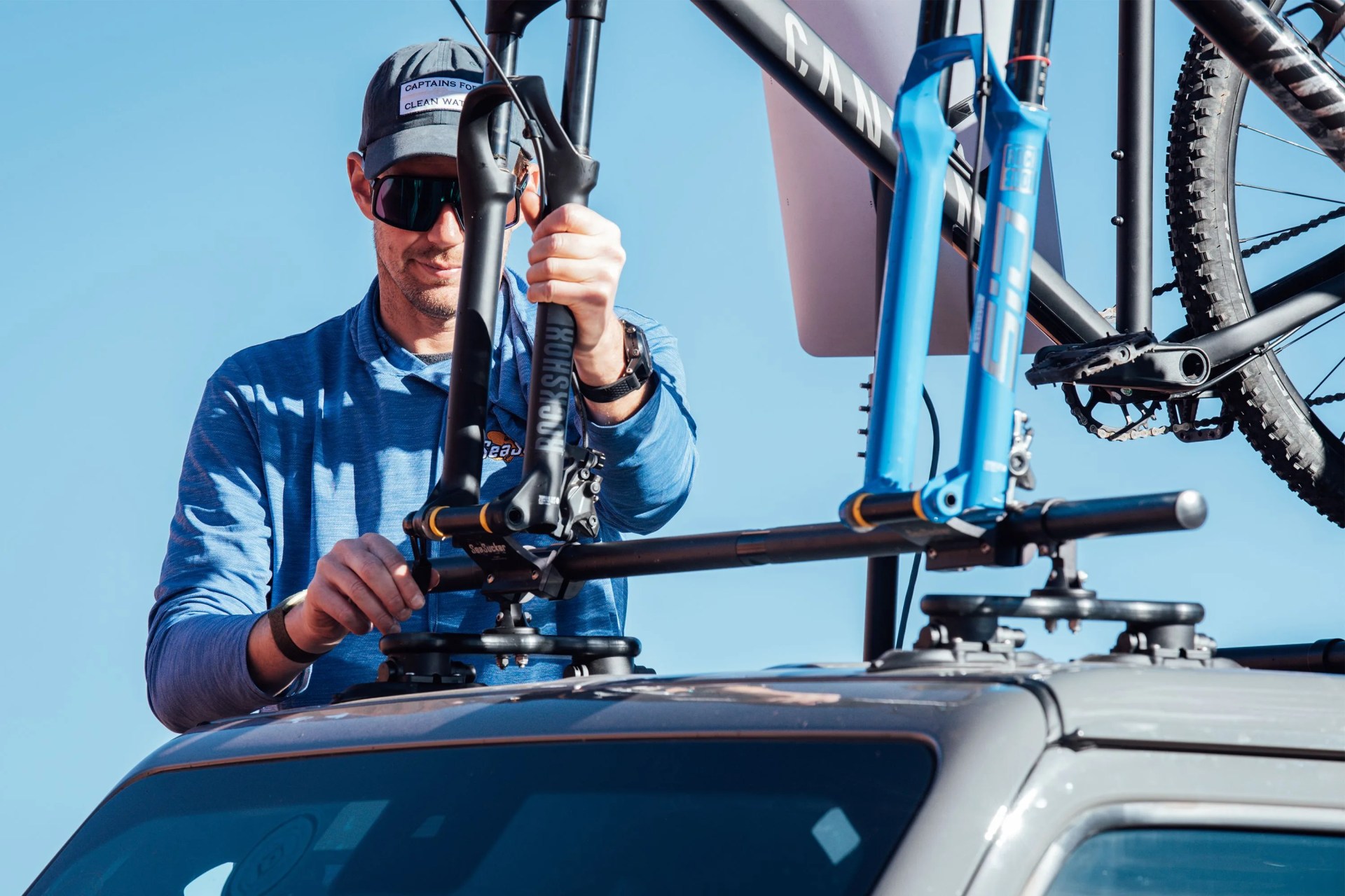 sea sucker bike mount man loading bike onto car mount