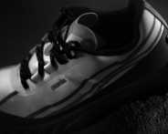 white and black trail running shoe on black background