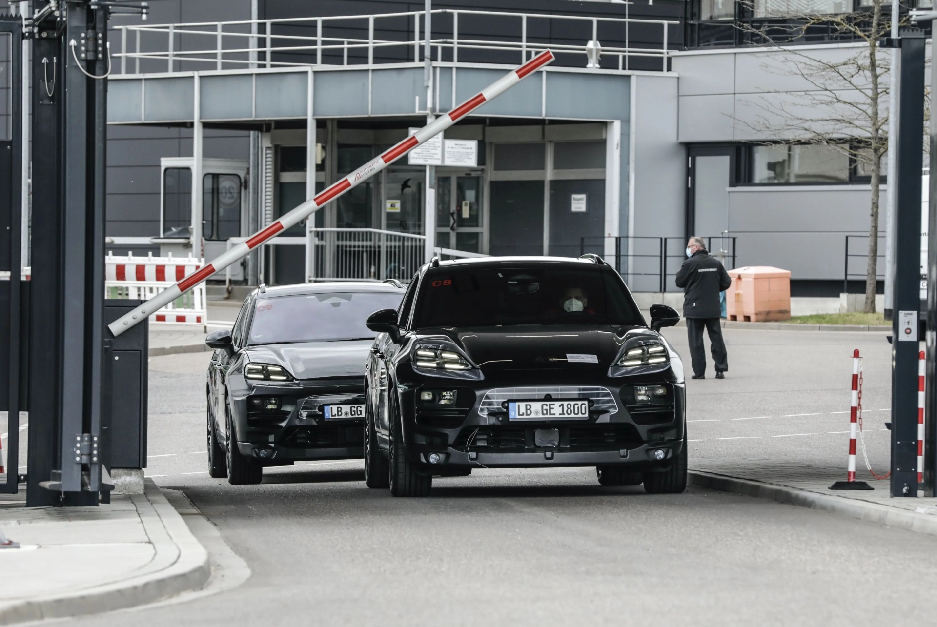 porsche electric macan exiting a porsche facility