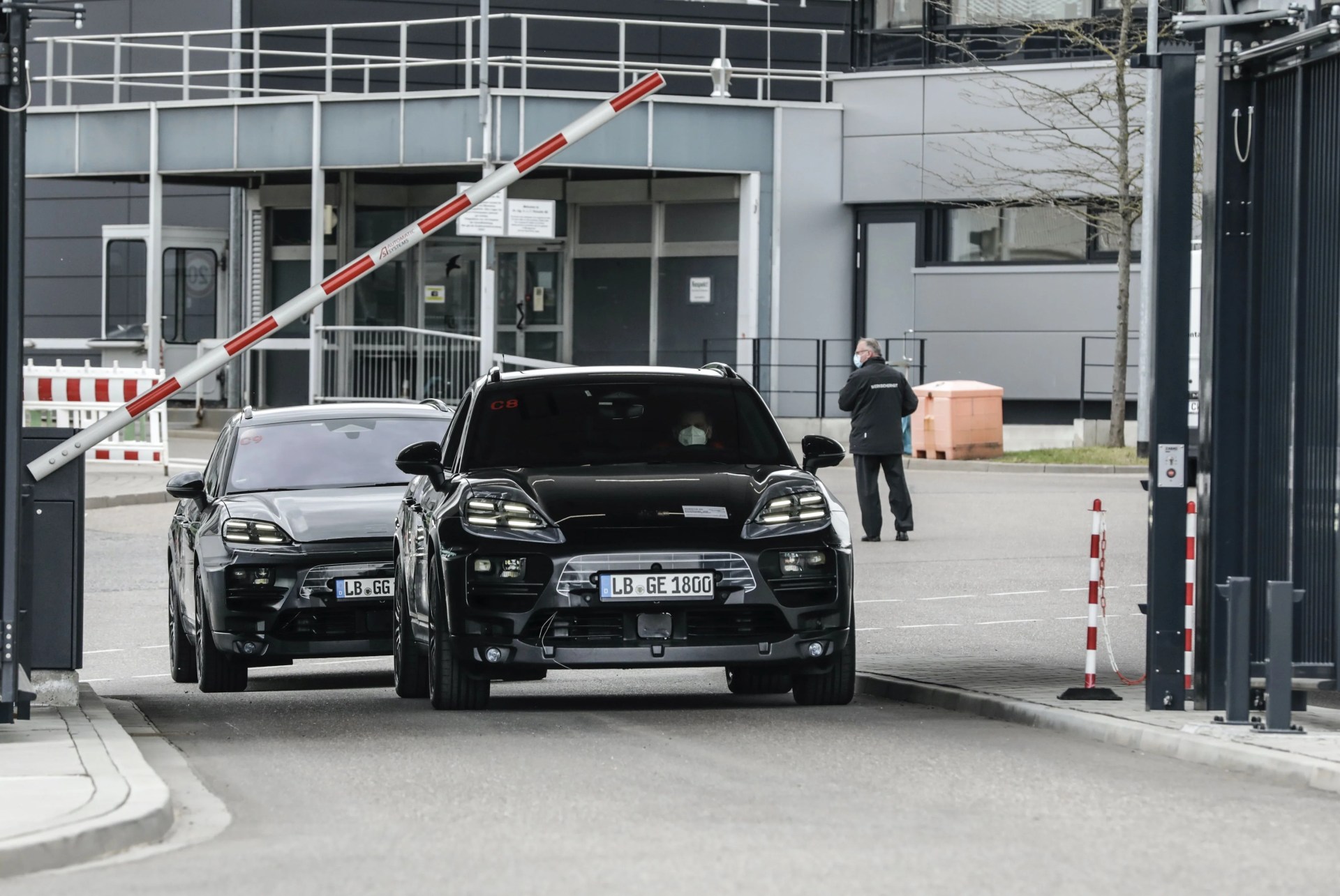 porsche electric macan exiting a porsche facility