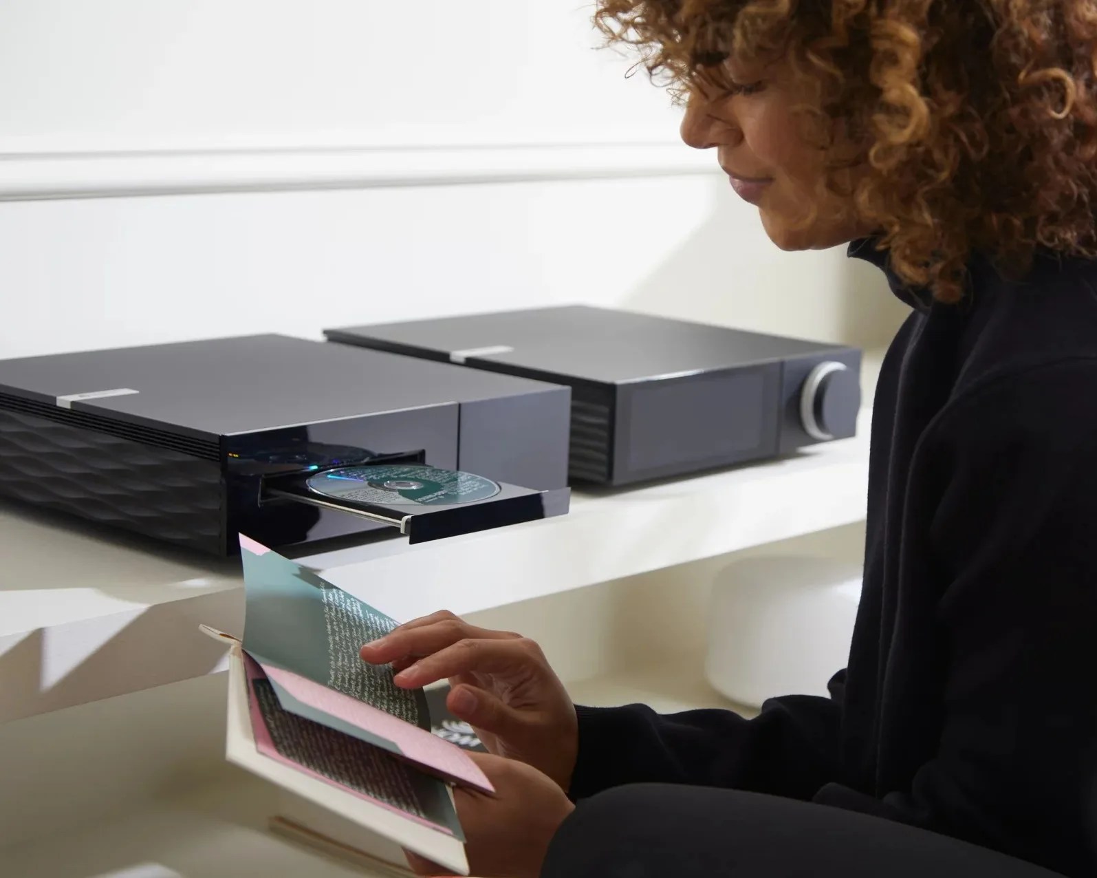 Woman reading a CD booklet