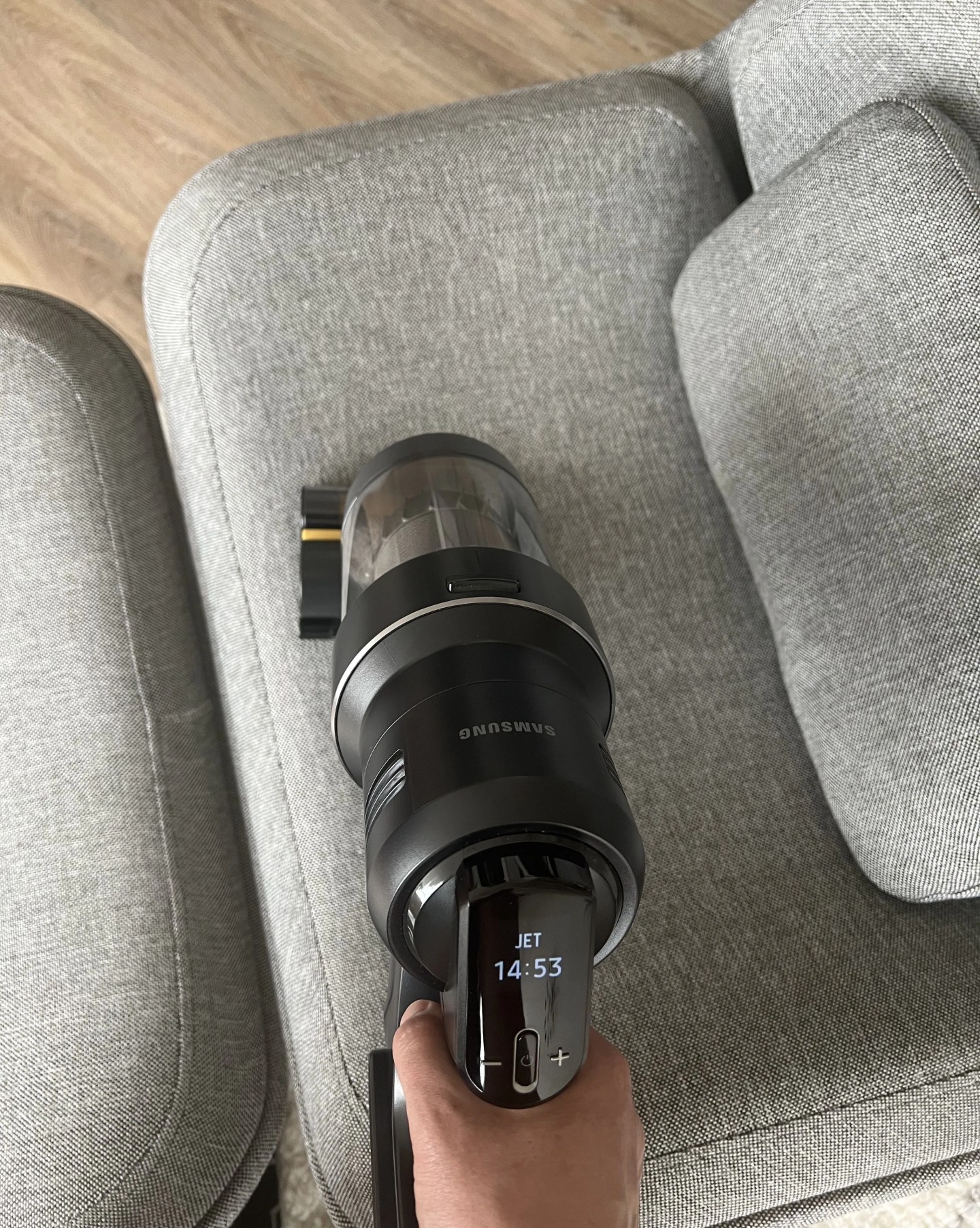 samsung bespoke jet ai vacuum in handheld mode cleaning a chair
