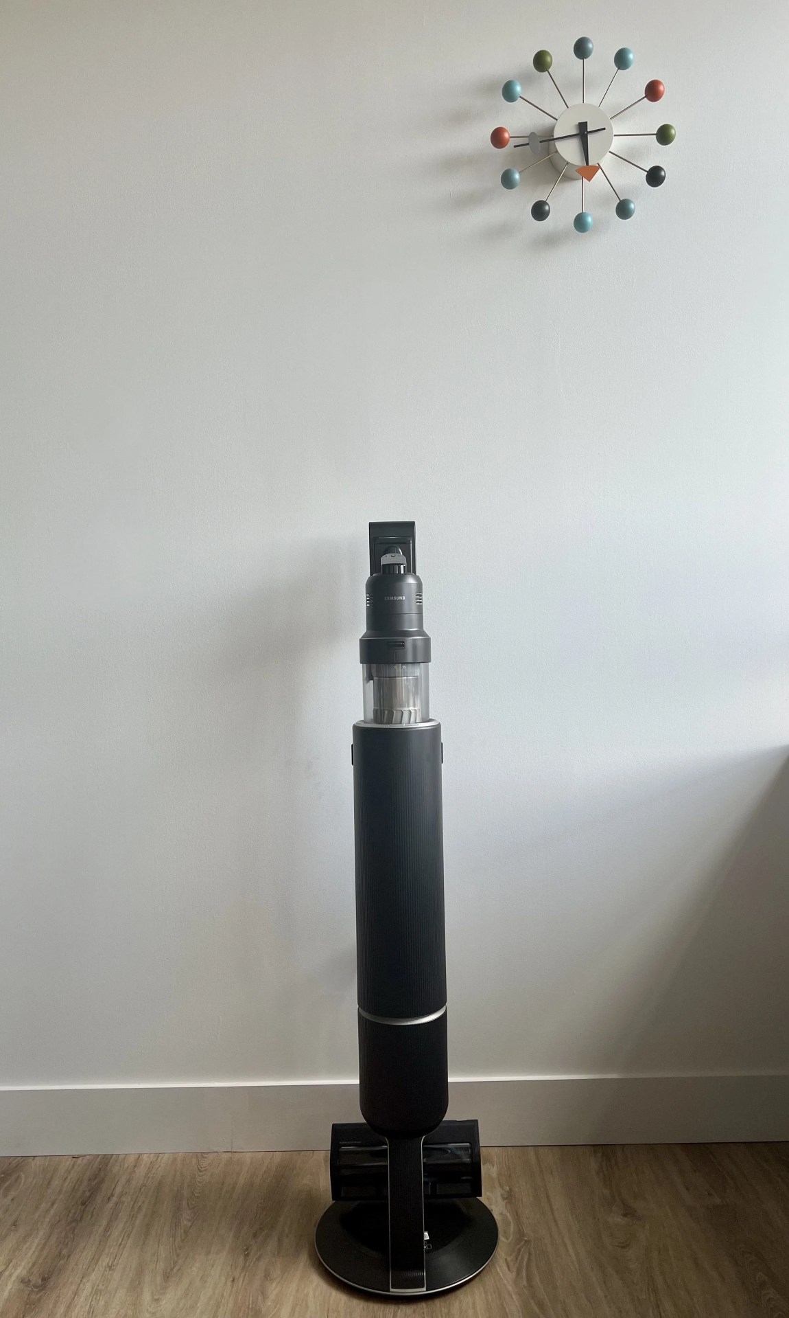 samsung bespoke jet ai vacuum next to ball clock
