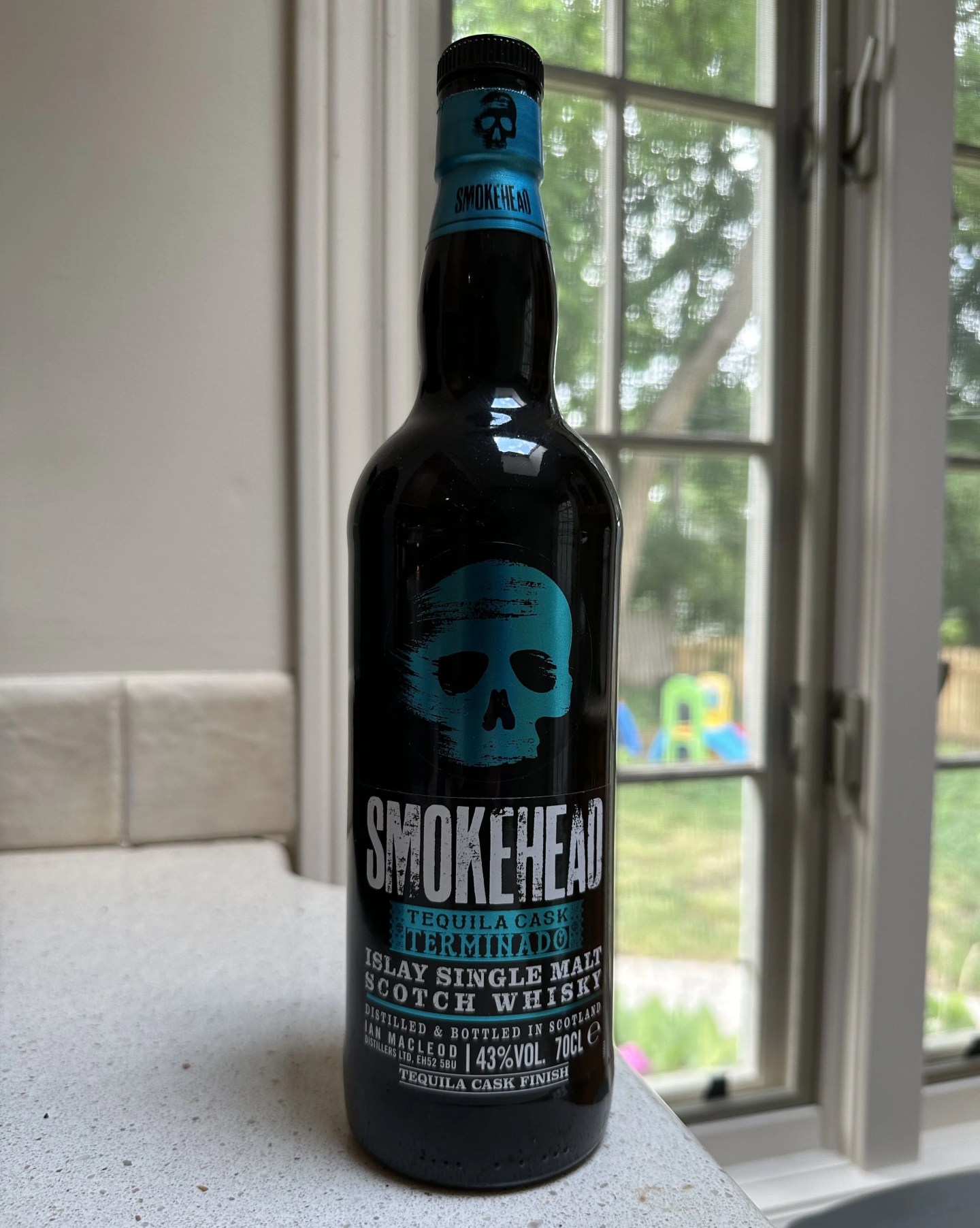 a bottle of smokehead termindao scotch on a kitchen counter