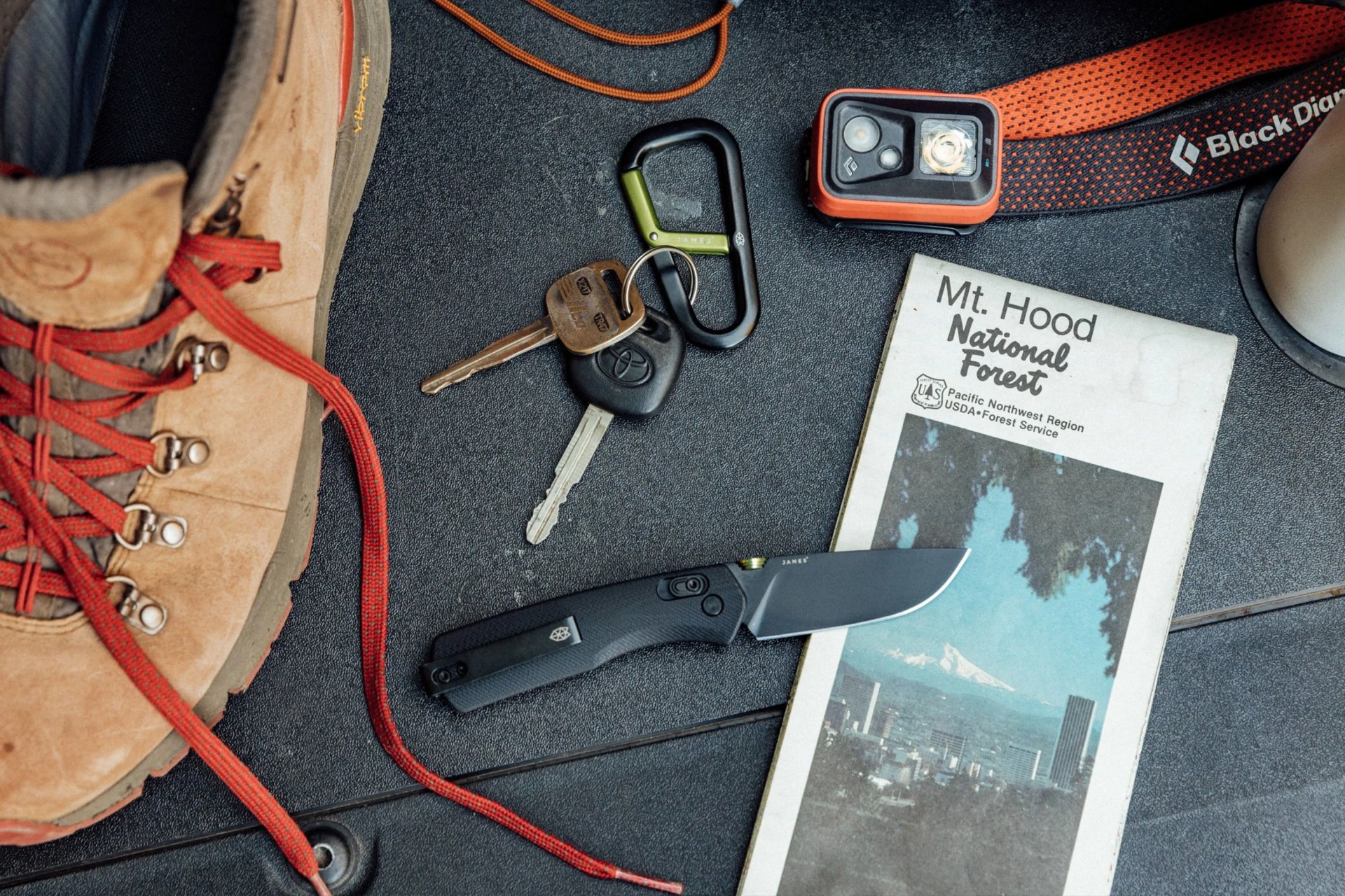 a knife and camping gear in the trunk of a car