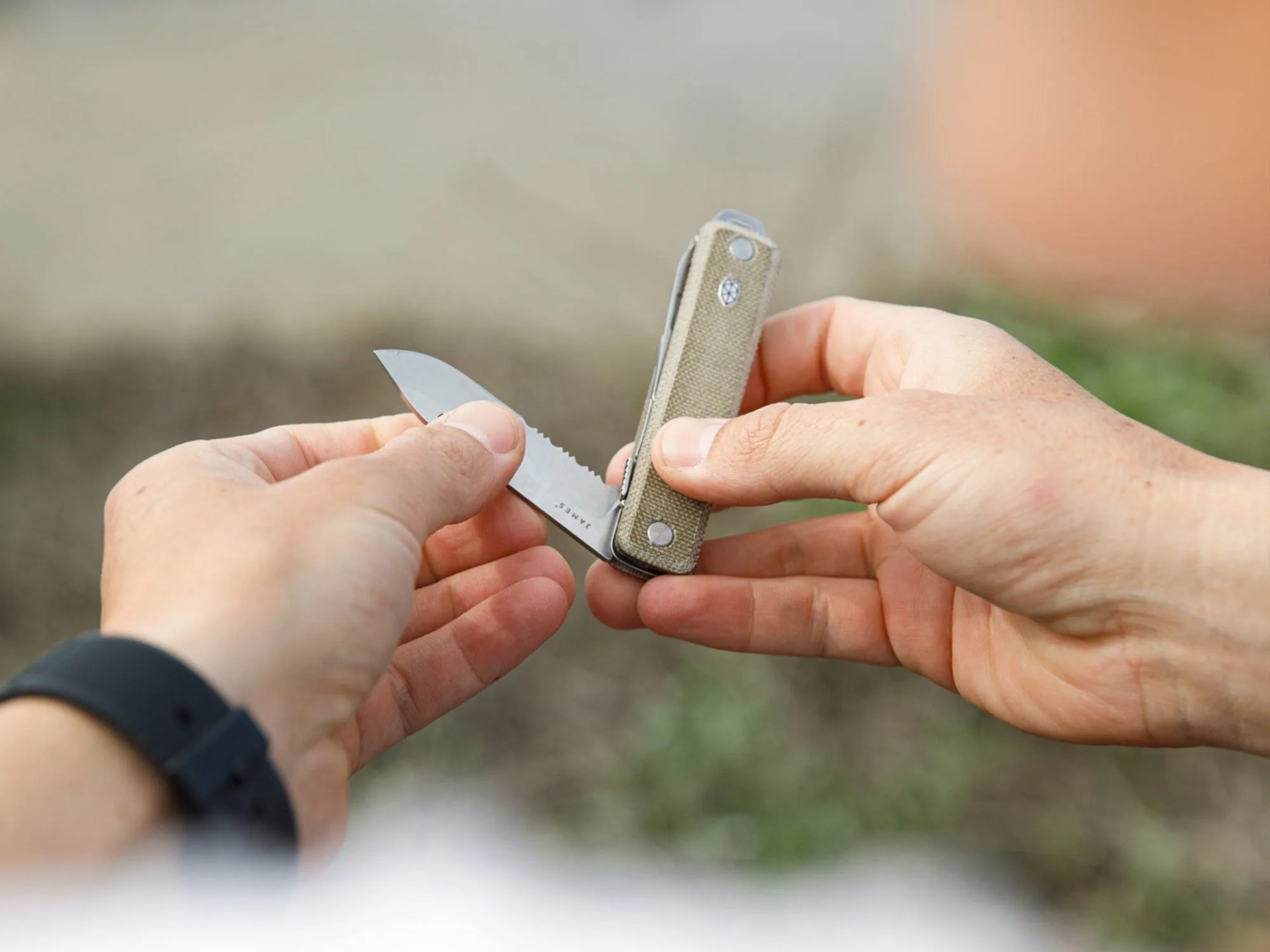 a person opening a pocket knife