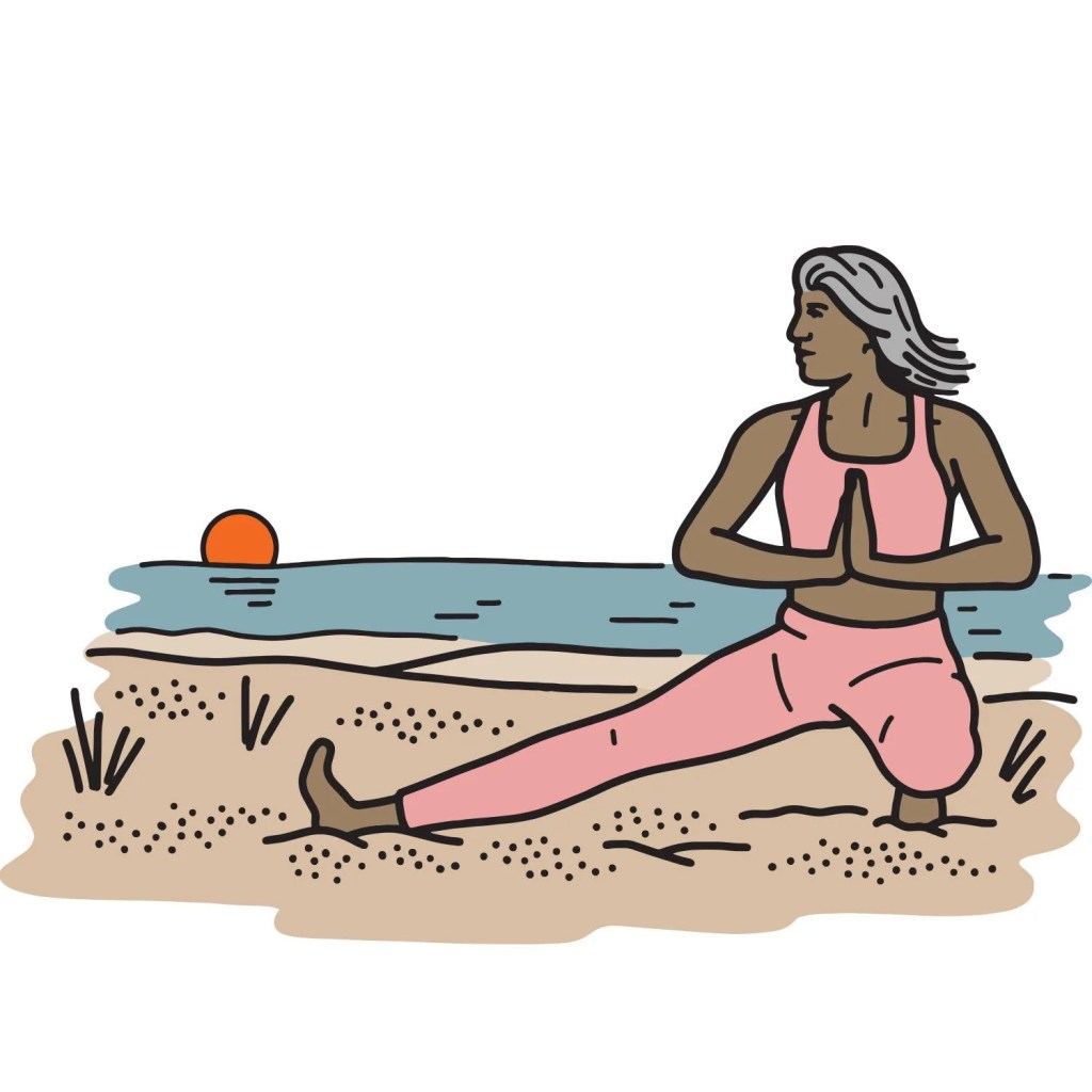 woman doing yoga on beach