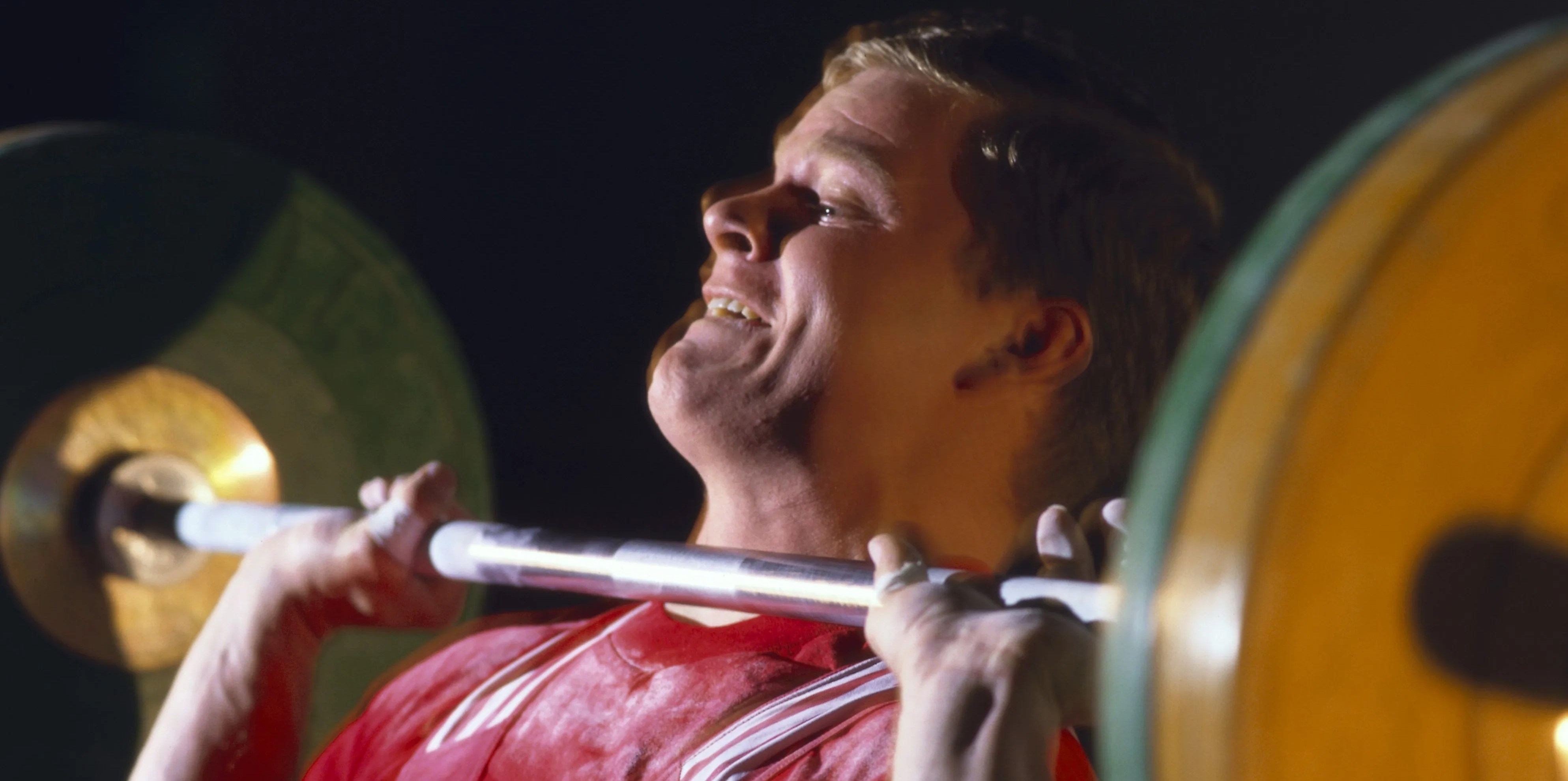 weight lifter pushing barbell