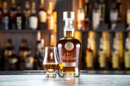 a bottle of whiskey and glass on a counter