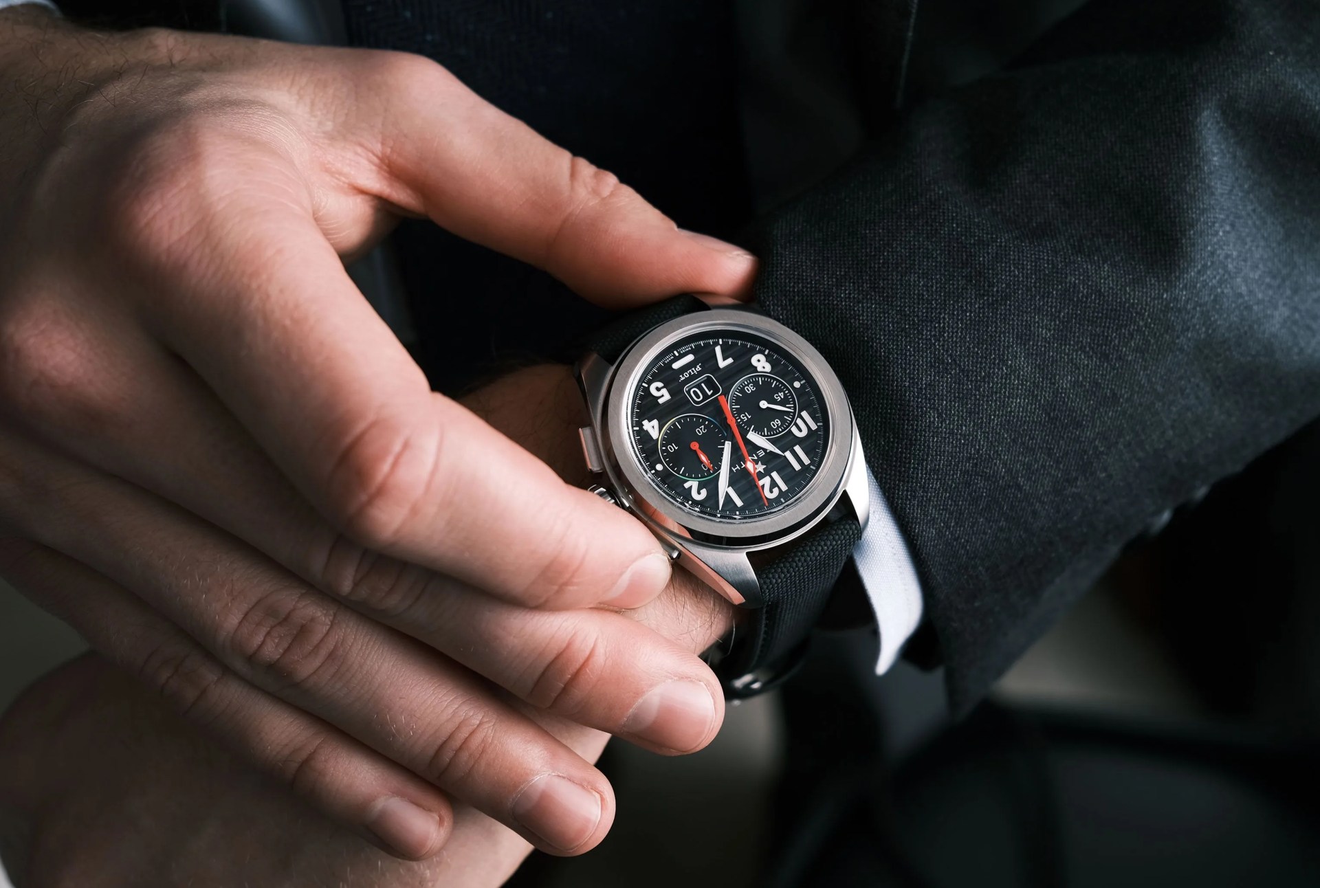 chronograph watch on wrist of man in suit