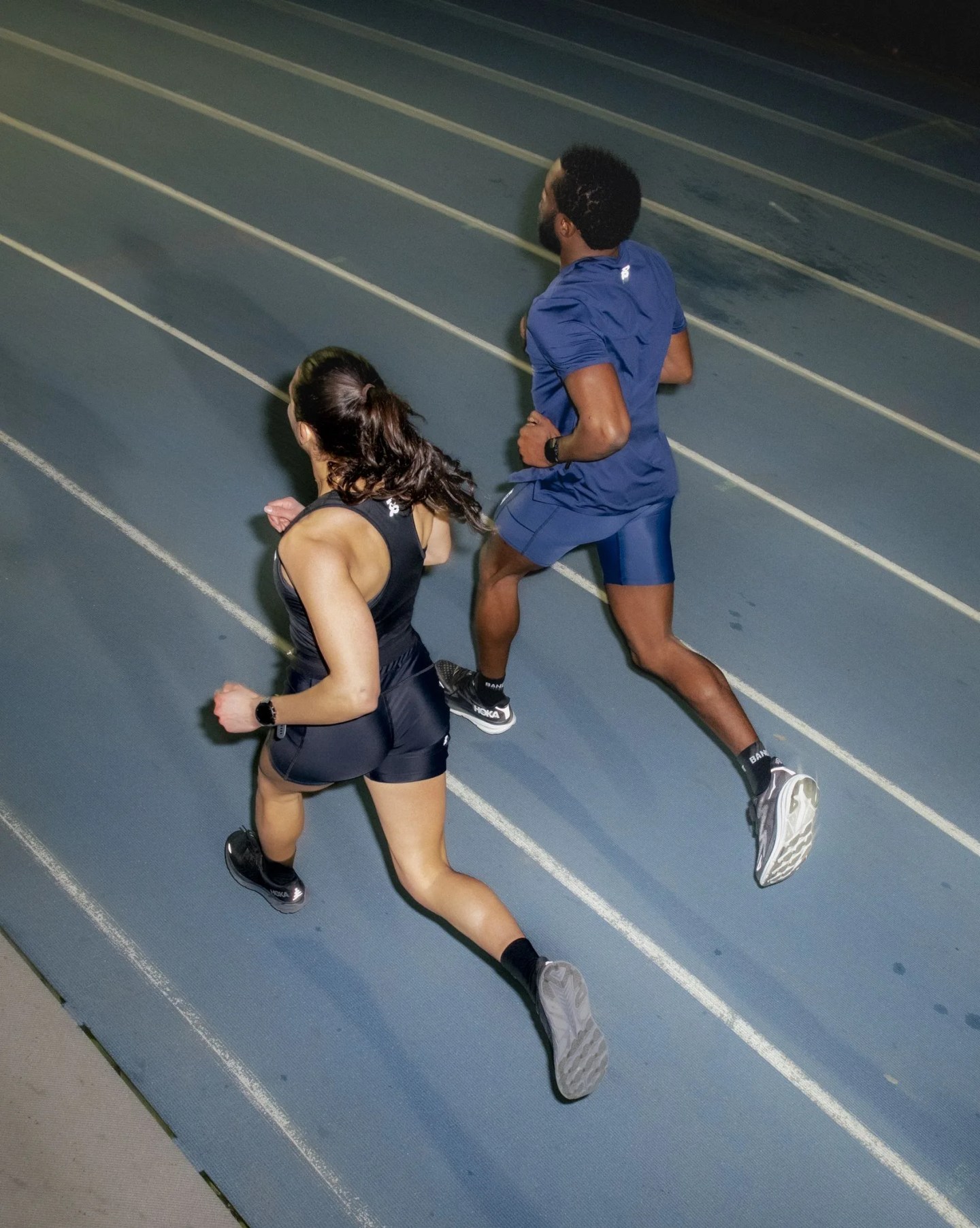 two people running on a track
