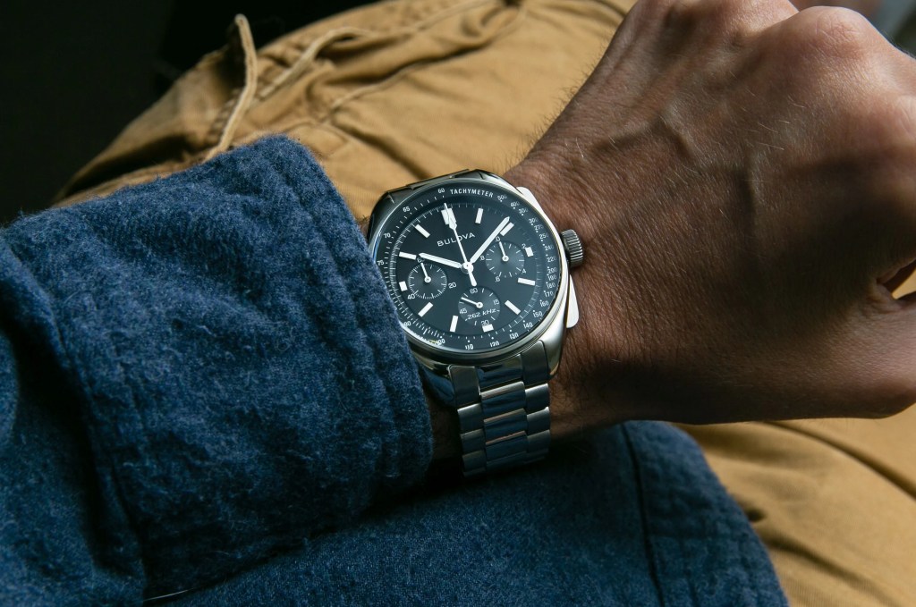 chronograph on a wrist with blue shirt and yellow pants