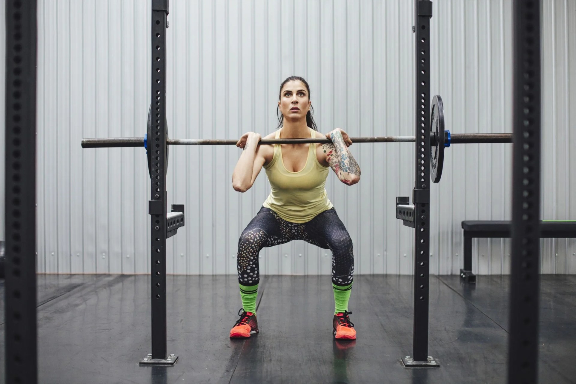 confident woman lifting deadlift in gym