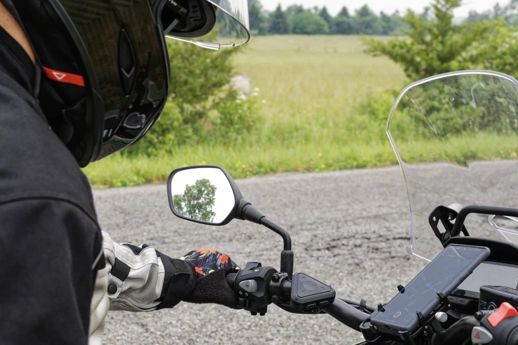 motorcycle rider with phone holder on handle bars