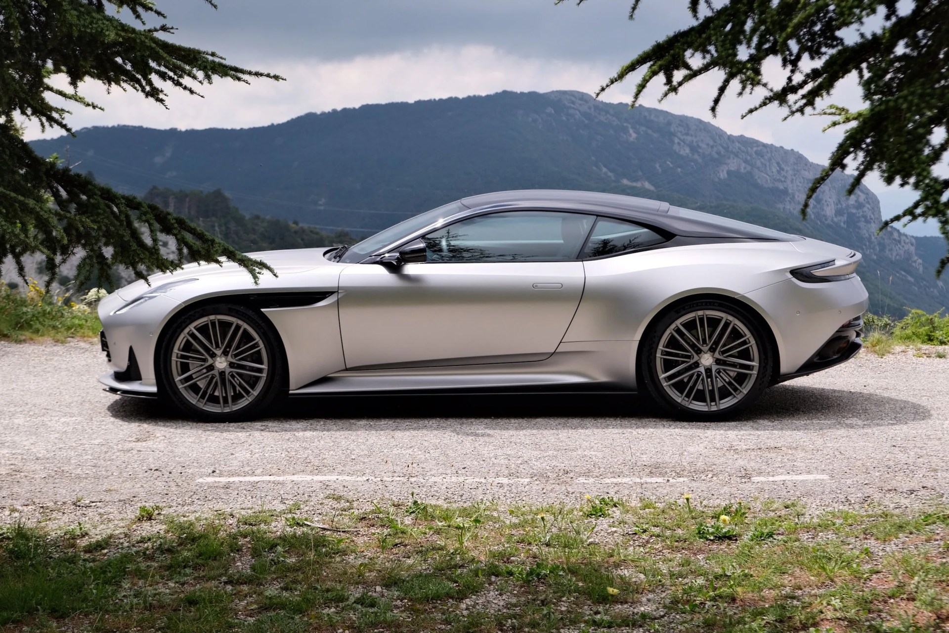 aston martin parked by a mountain
