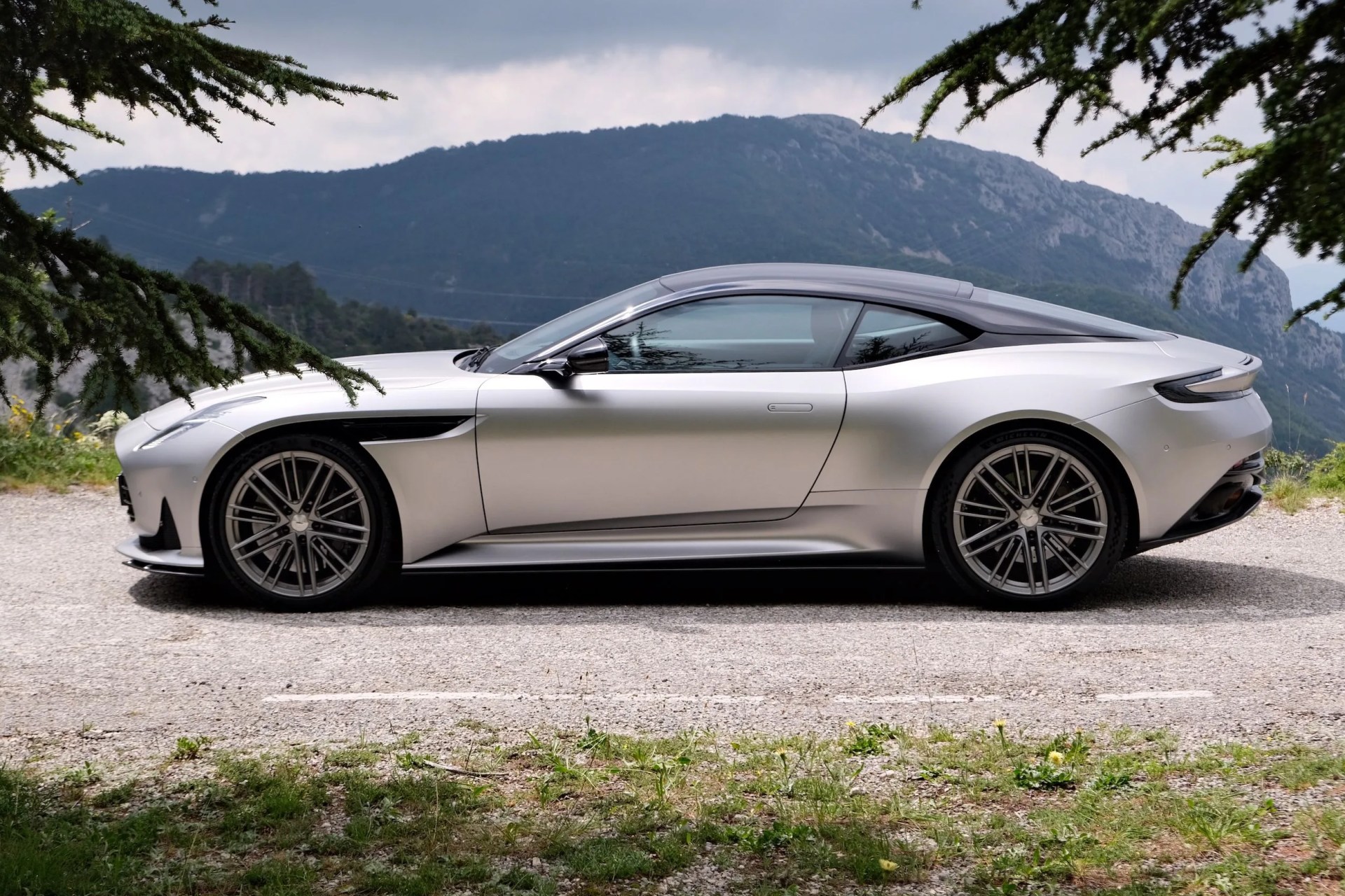 aston martin parked by a mountain