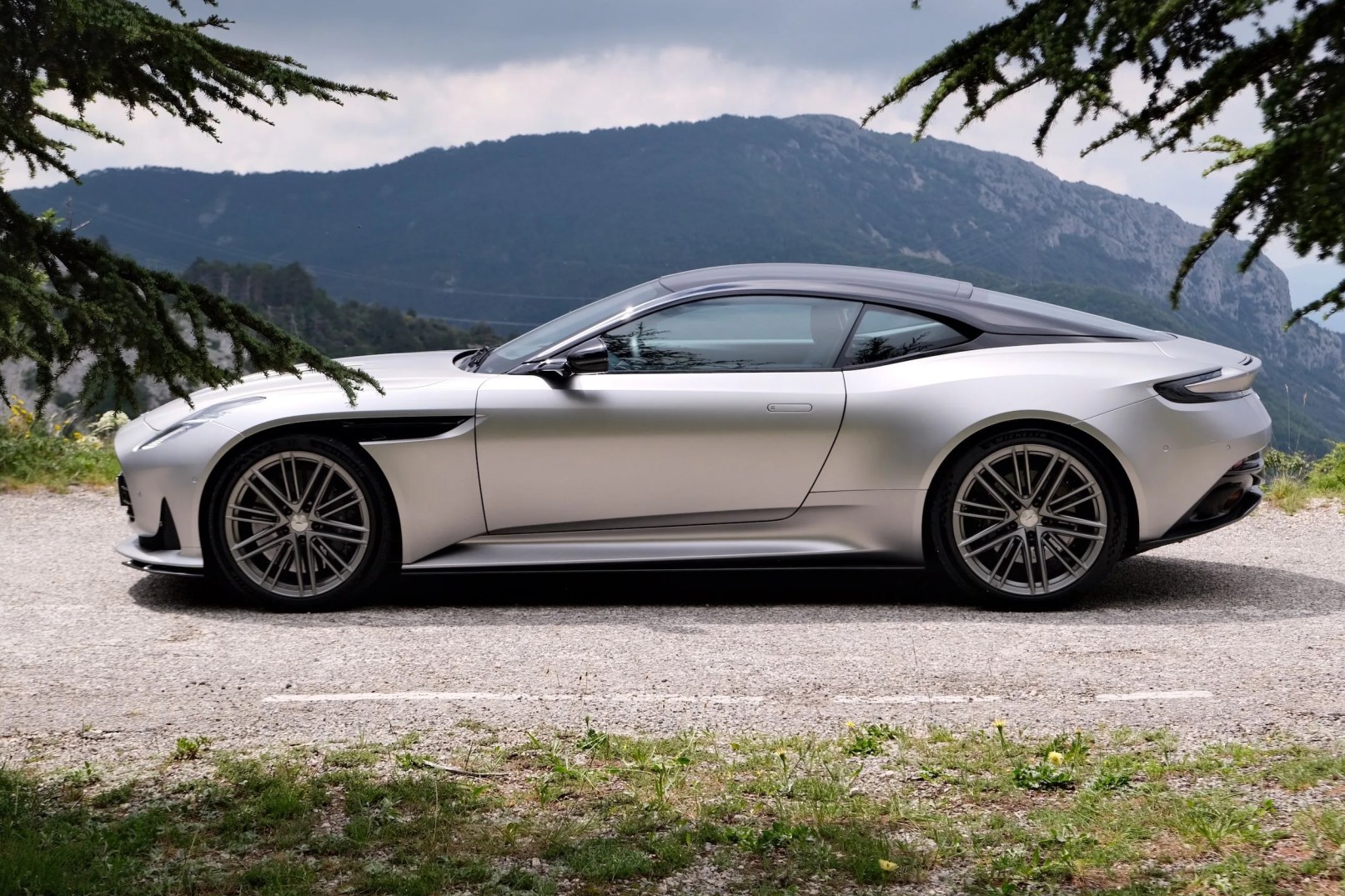 aston martin parked by a mountain