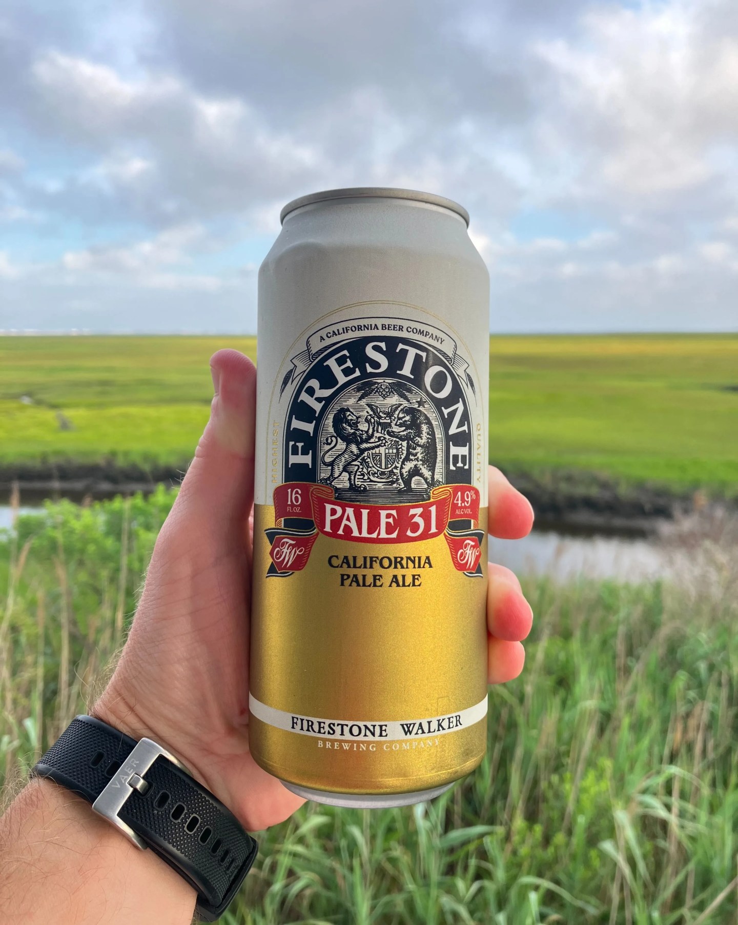 a hand holds a can of firestone walker pale ale