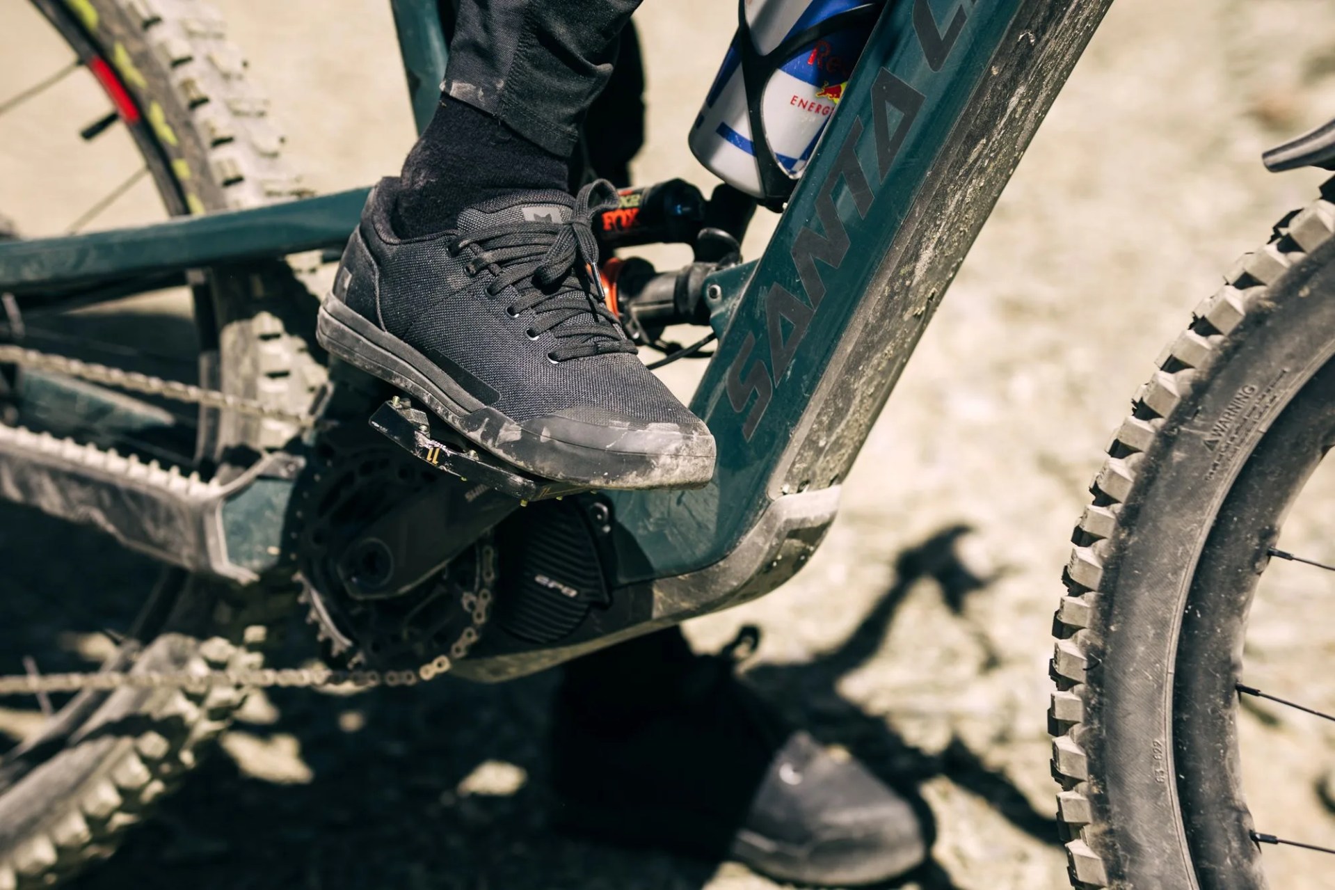 man wearing sneaker from fox raising riding bike