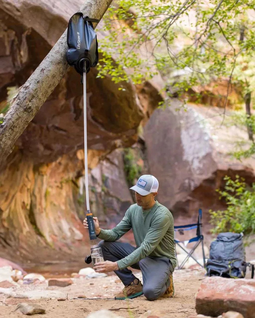 man using lifestraw peak series gravity purifier with virus removal