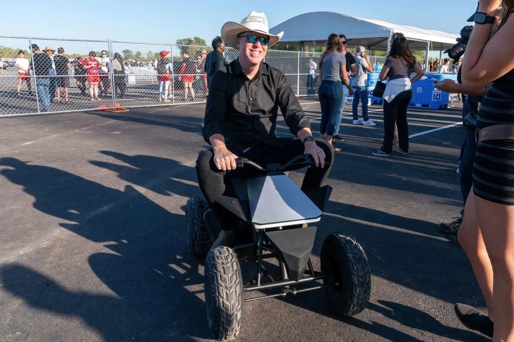 cowboy hat guy riding a tesla cyber quad