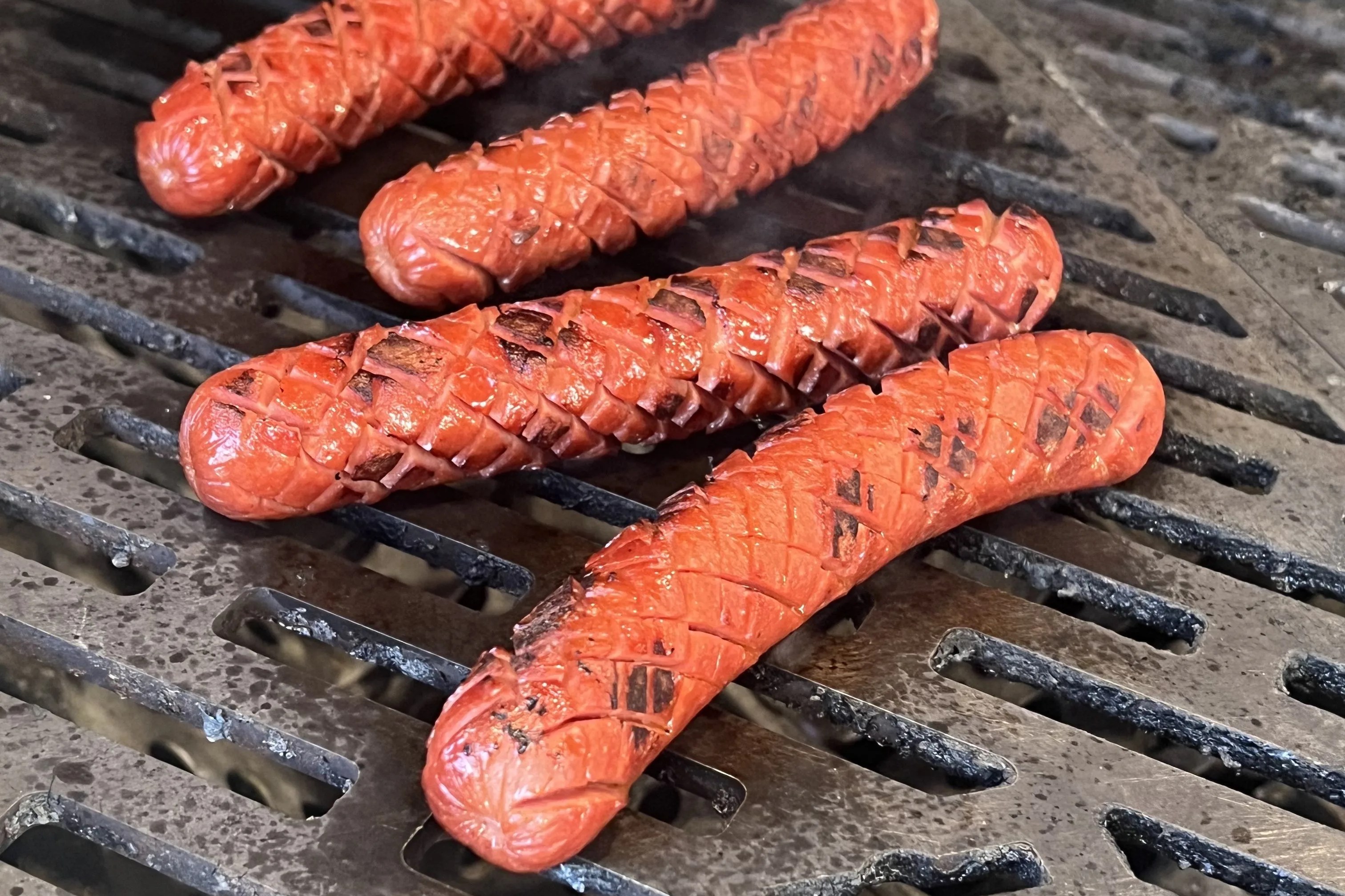 hot dogs on a grill