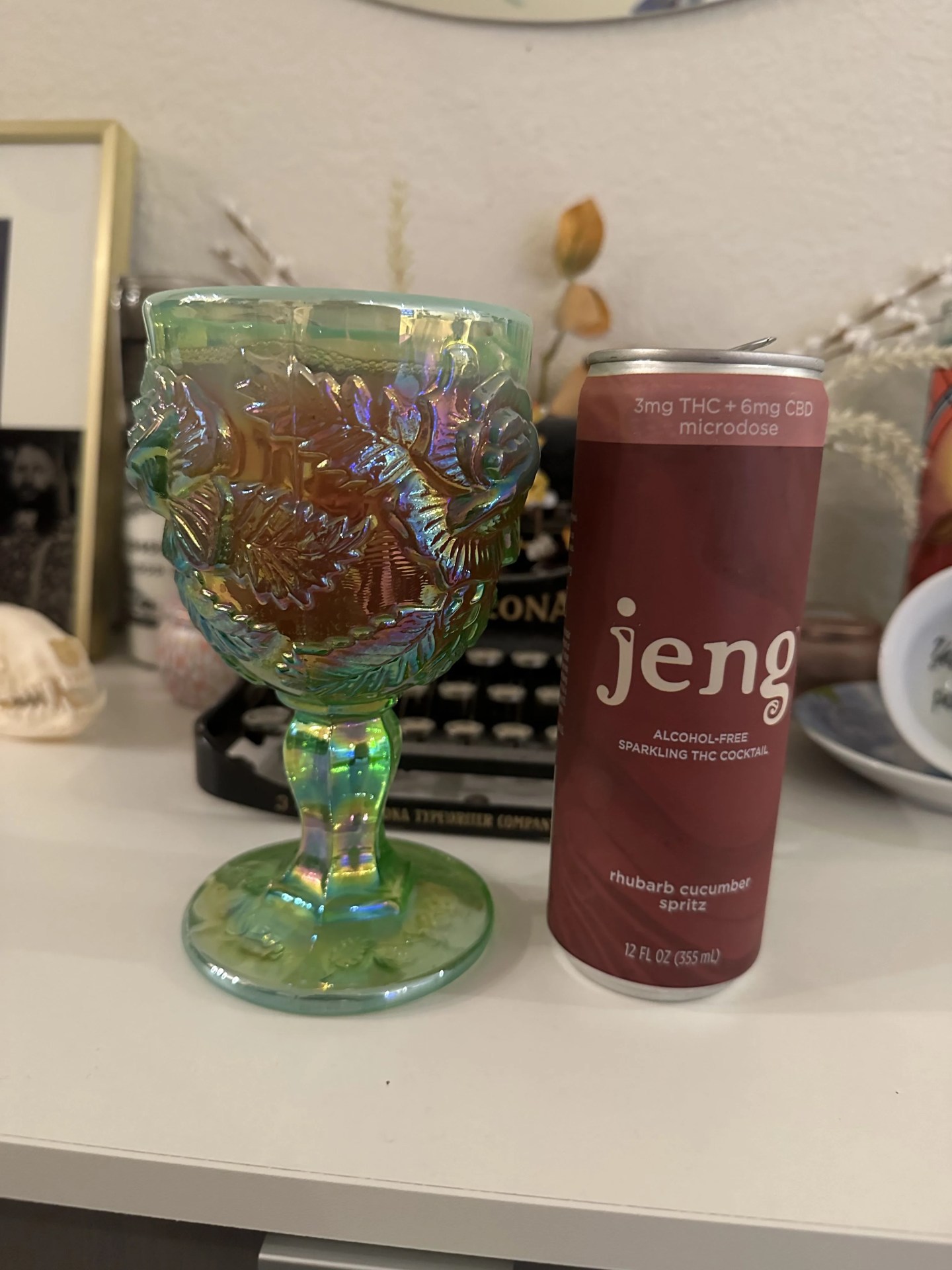 a can of jeng thc beverage next to a goblet